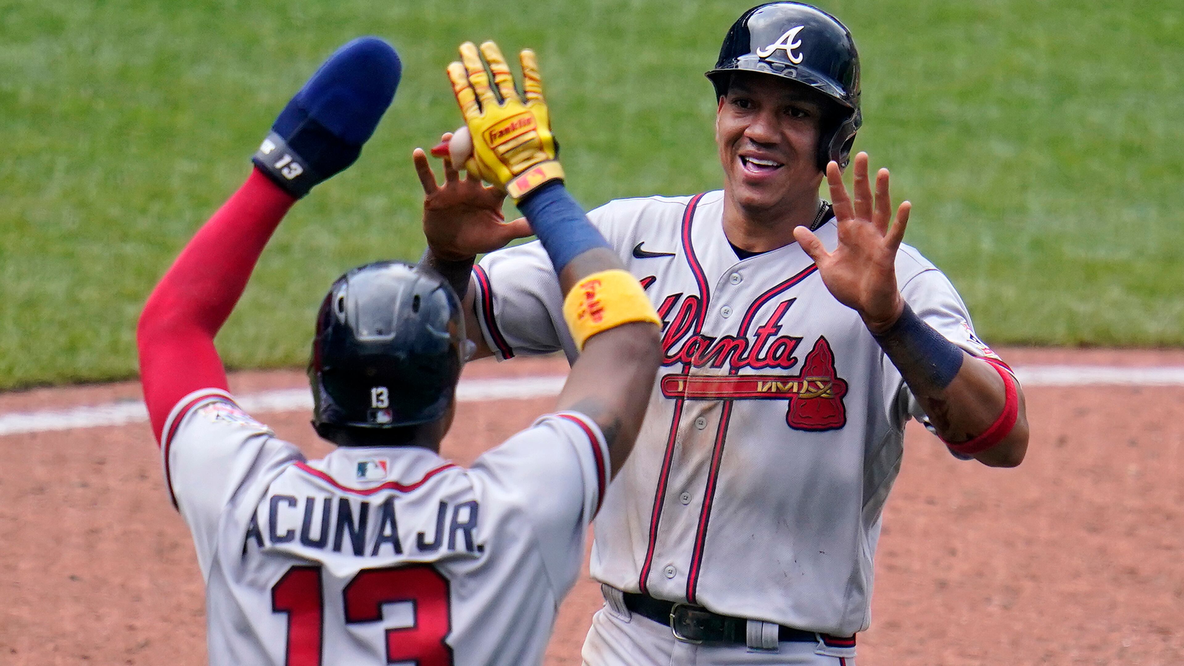 Ehire Adrianza and Ronald Acuna celebrate after scoring on a single by Orlando Arcia in the sixth inning of Wednesday's Braves-Pirates game in Pittsburgh.