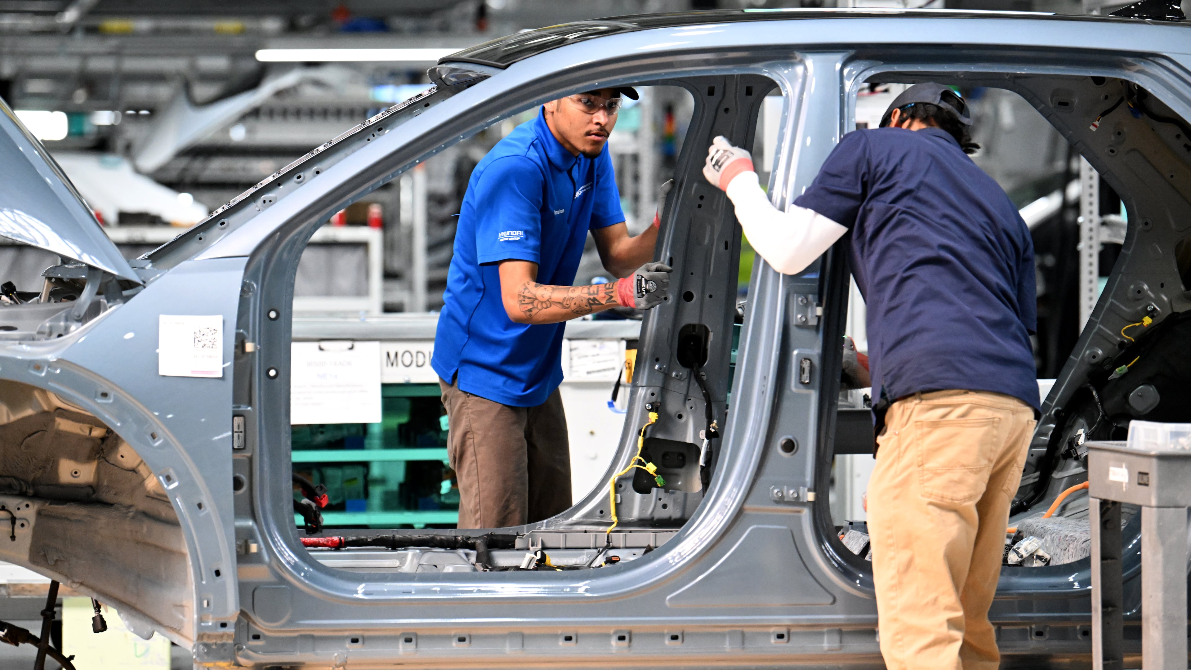 Workers check a Hyundai IONIQ 5 on the EV assembly line at Hyundai Motor Group Metaplant America in Ellabell near the Georgia coastal city of Savannah on Wednesday, May 6, 2026. (Hyosub Shin/AJC)
