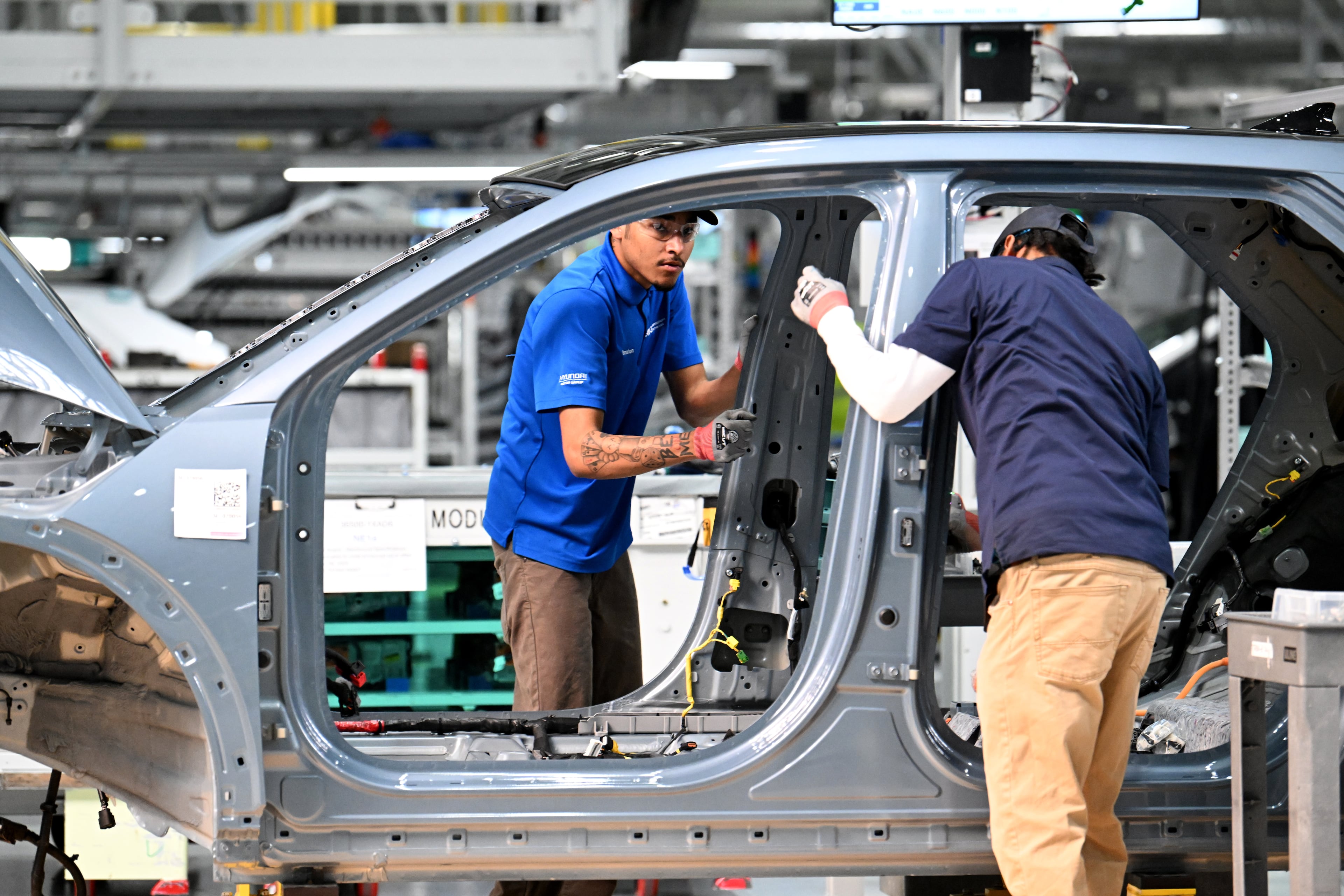 Workers check a Hyundai IONIQ 5 on the EV assembly line at Hyundai Motor Group Metaplant America in Ellabell near the Georgia coastal city of Savannah on Wednesday, May 6, 2026. (Hyosub Shin/AJC)