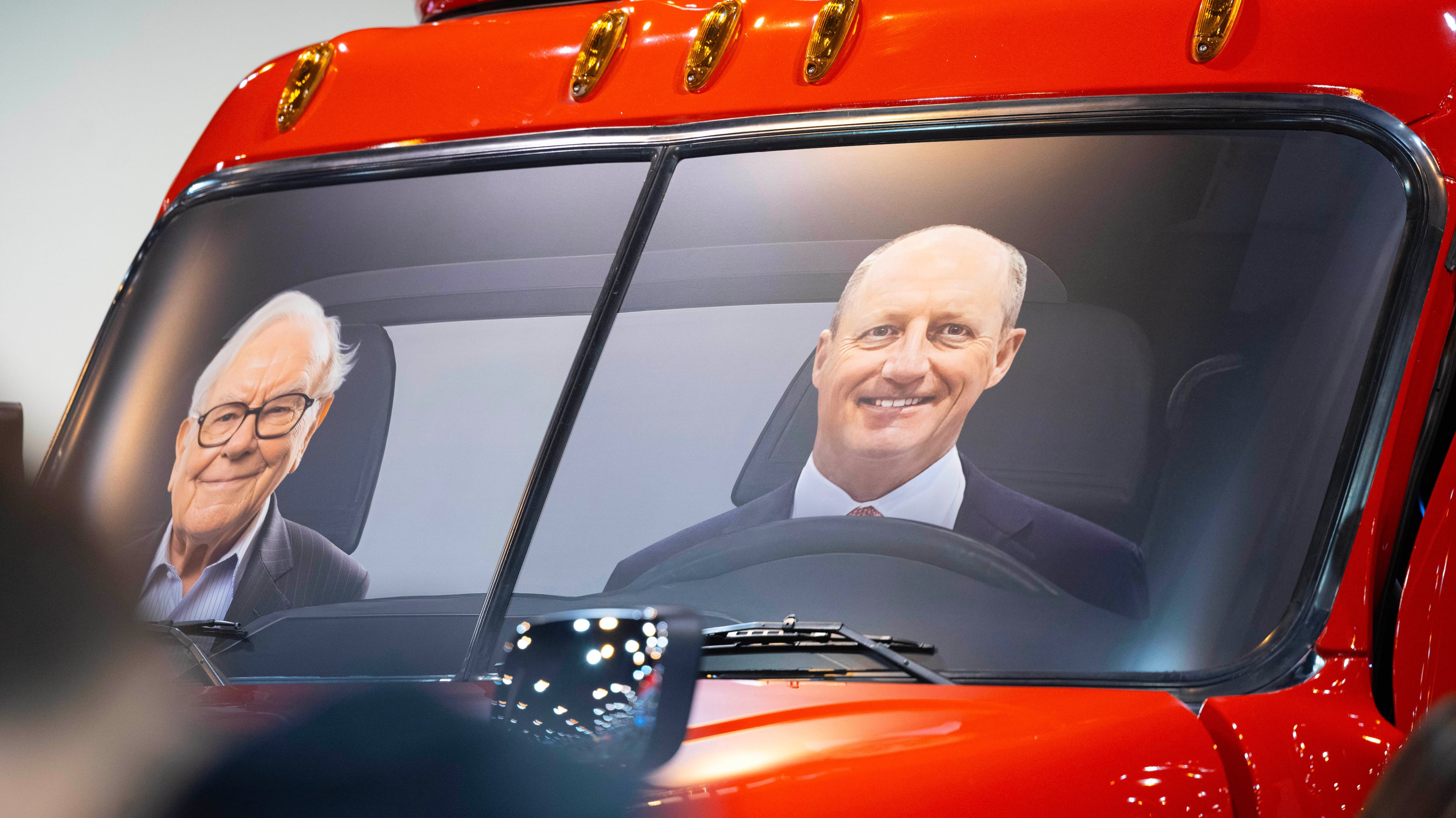 FILE - Portraits of Berkshire Hathaway's Warren Buffett, left, and CEO Greg Abel sit in a semi truck at the Pilot display in the Berkshire Hathaway annual meeting on May 2, 2026, in Omaha, Neb. (AP Photo/Rebecca S. Gratz, file)