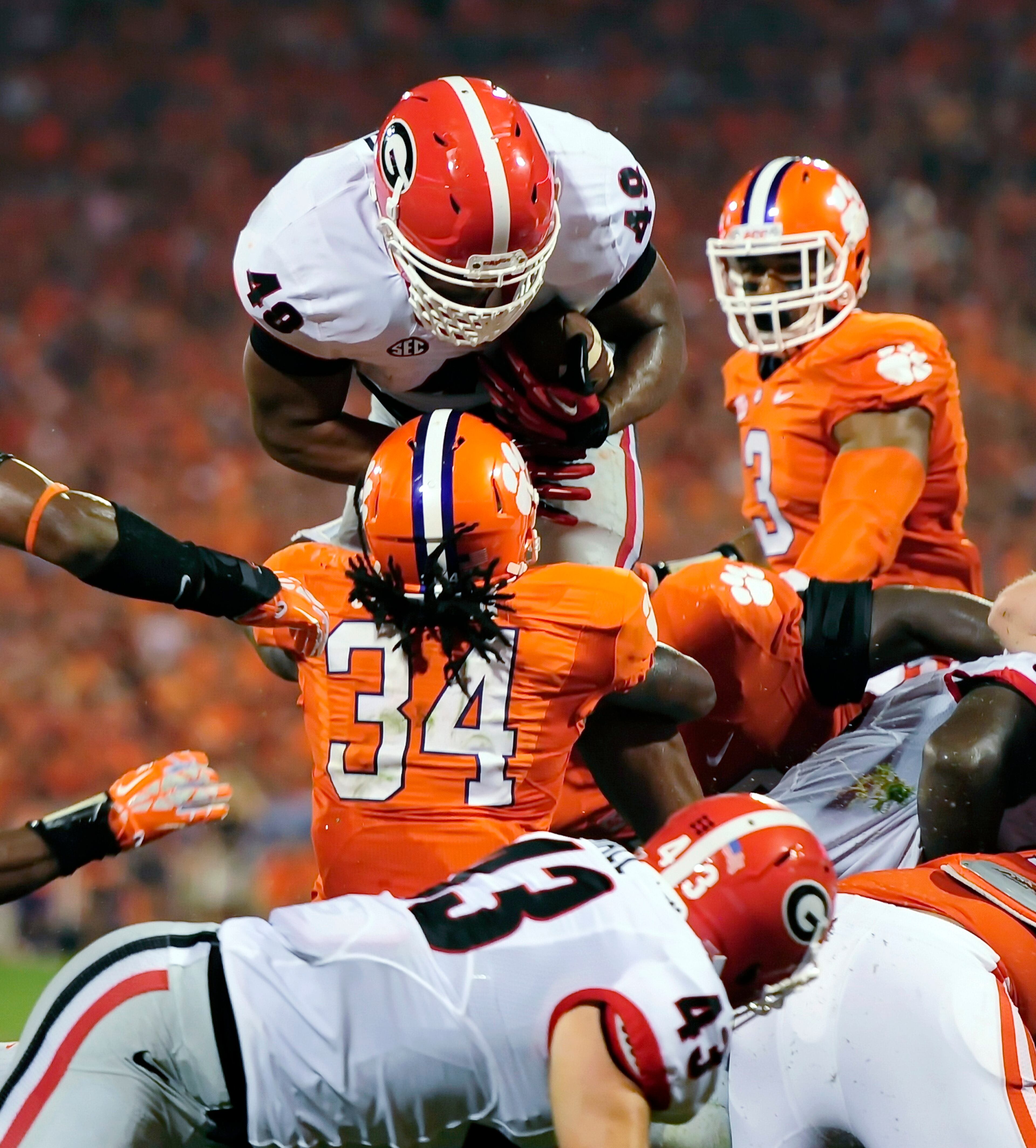 Georgia fullback Quayvon Hicks is stopped at the goal line by Clemson's Quandon Christian during the second half of an NCAA college football game, Saturday, Aug. 31, 2013, at Memorial Stadium in Clemson, S.C. (AP Photo/ Richard Shiro)