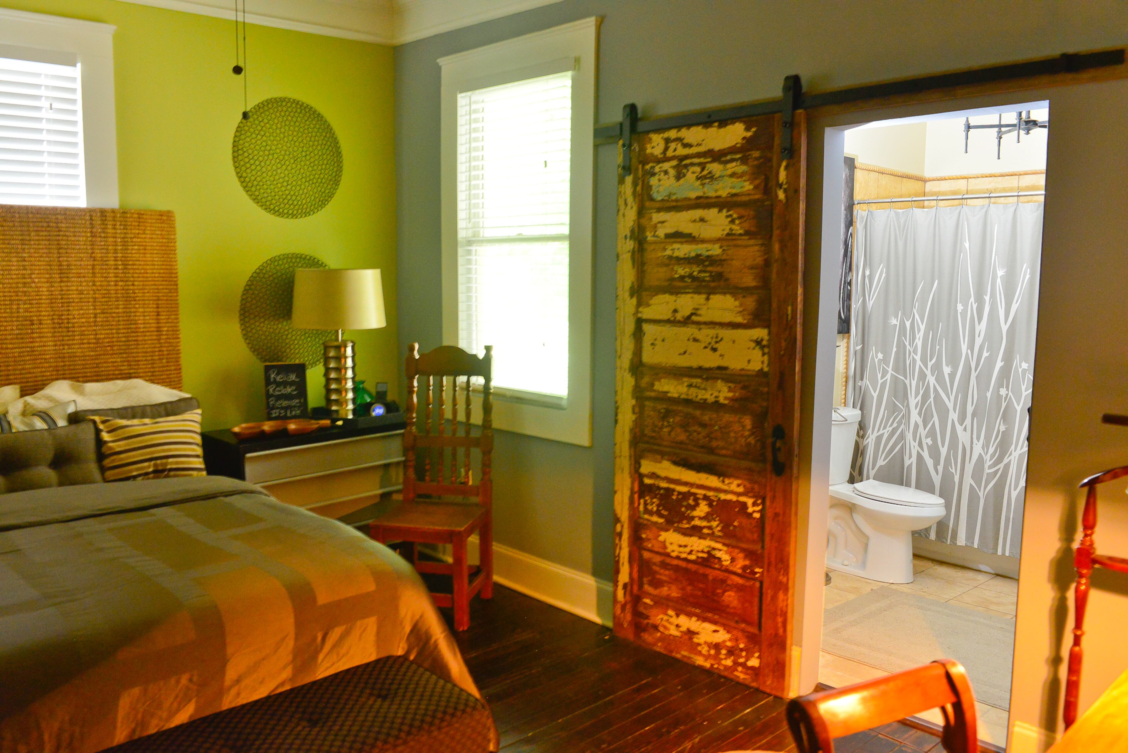 In the guest bedroom, Walker added a sliding door at the opening to the bathroom. "I like taking old doors and creating sliding doors out of them," he says. "We added a barnyard door that I found on the side of the street."