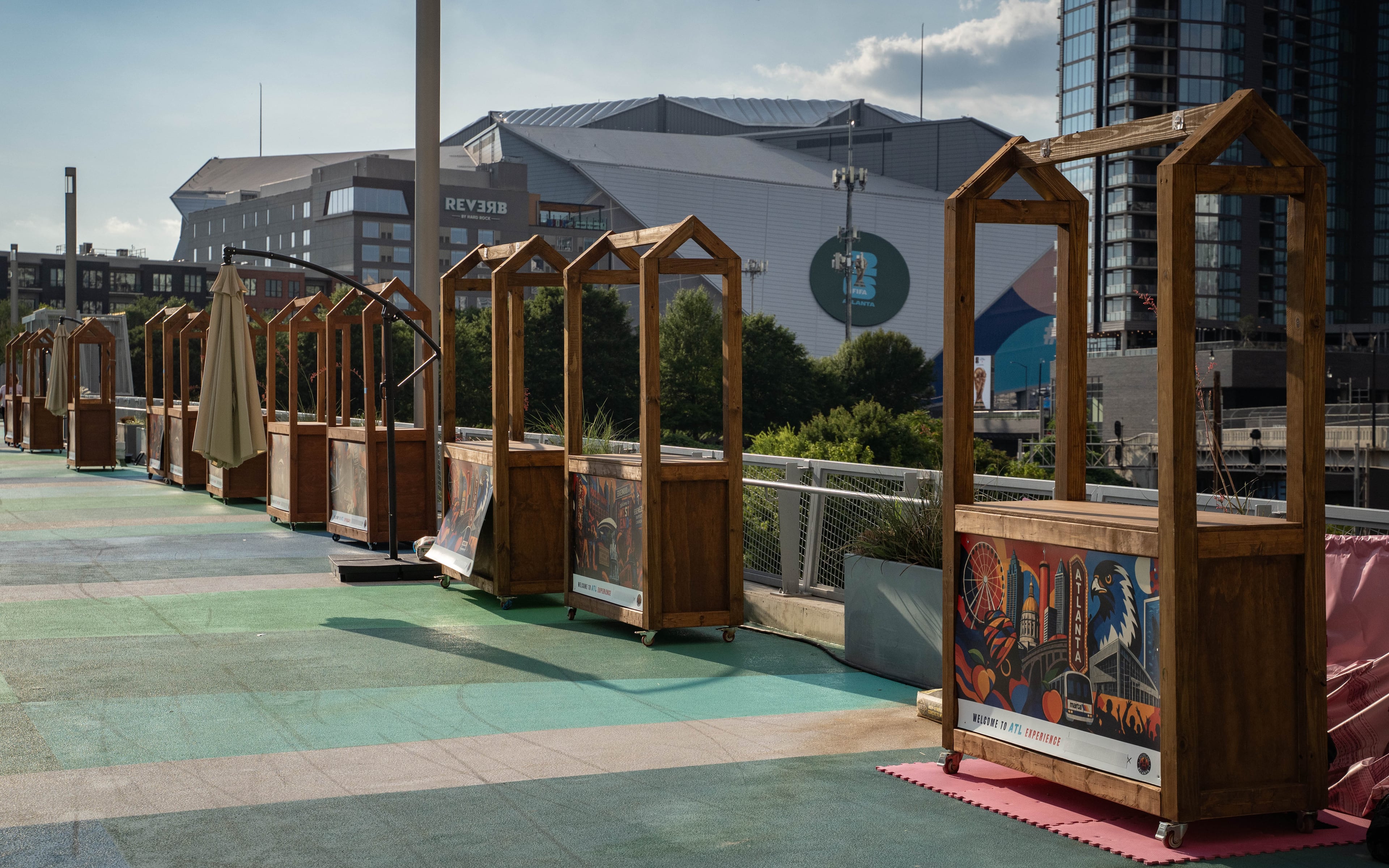 Vendor booths sit empty in the shadow of Atlanta Stadium (Mercedes-Benz Stadium) on the Steele Bridge in downtown Atlanta on June 24, 2026. (Ben Hendren for the AJC)