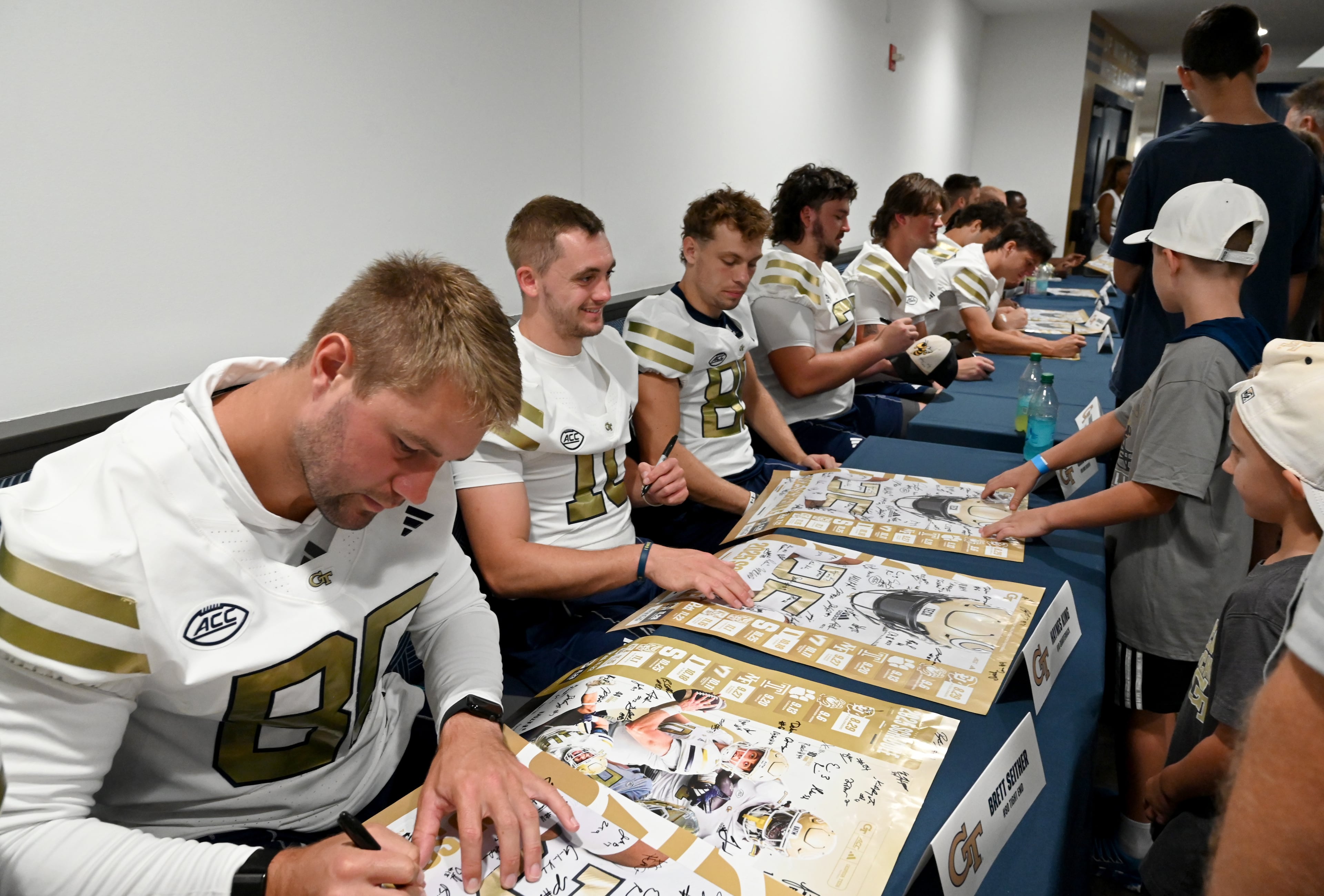 Georgia Tech tight end Brett Seither (left) and quarterback Haynes King (10) sign autographs for event attendees during the annual “First Saturday on The Flats” at Bobby Dodd Stadium, Saturday, August 2, 2025, in Atlanta. The Flats provides Tech fans with the opportunity to engage with their favorite Yellow Jackets ahead of the upcoming 2025 season. The event offers a variety of entertaining activities for the whole family, including a DJ, autograph opportunities, tailgate games and interactive experiences right on the field at Bobby Dodd Stadium. (Hyosub Shin / AJC)