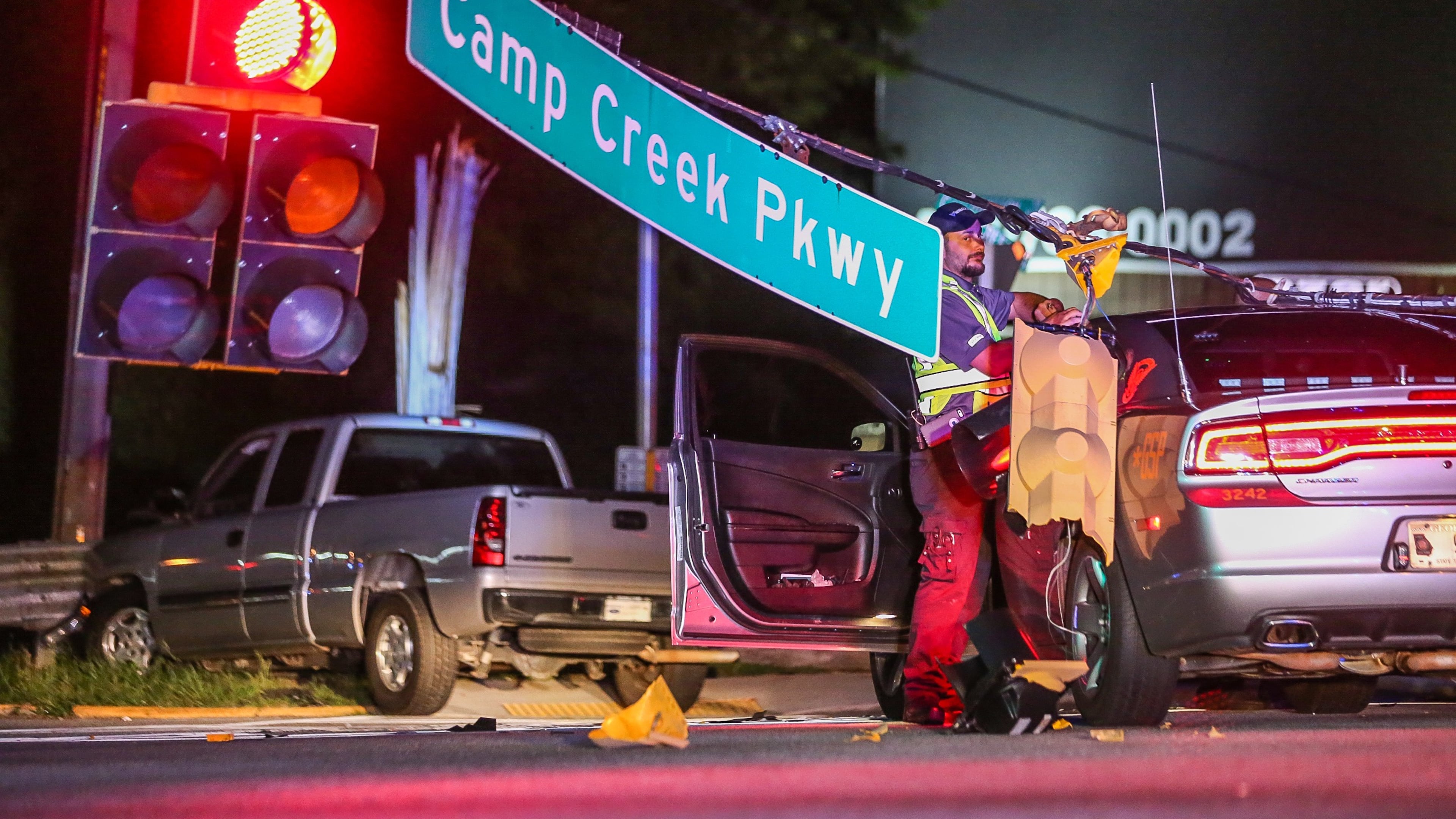 A predawn police chase Monday ended with a crash at the intersection of Camp Creek Parkway and Washington Road. JOHN SPINK / JSPINK@AJC.COM