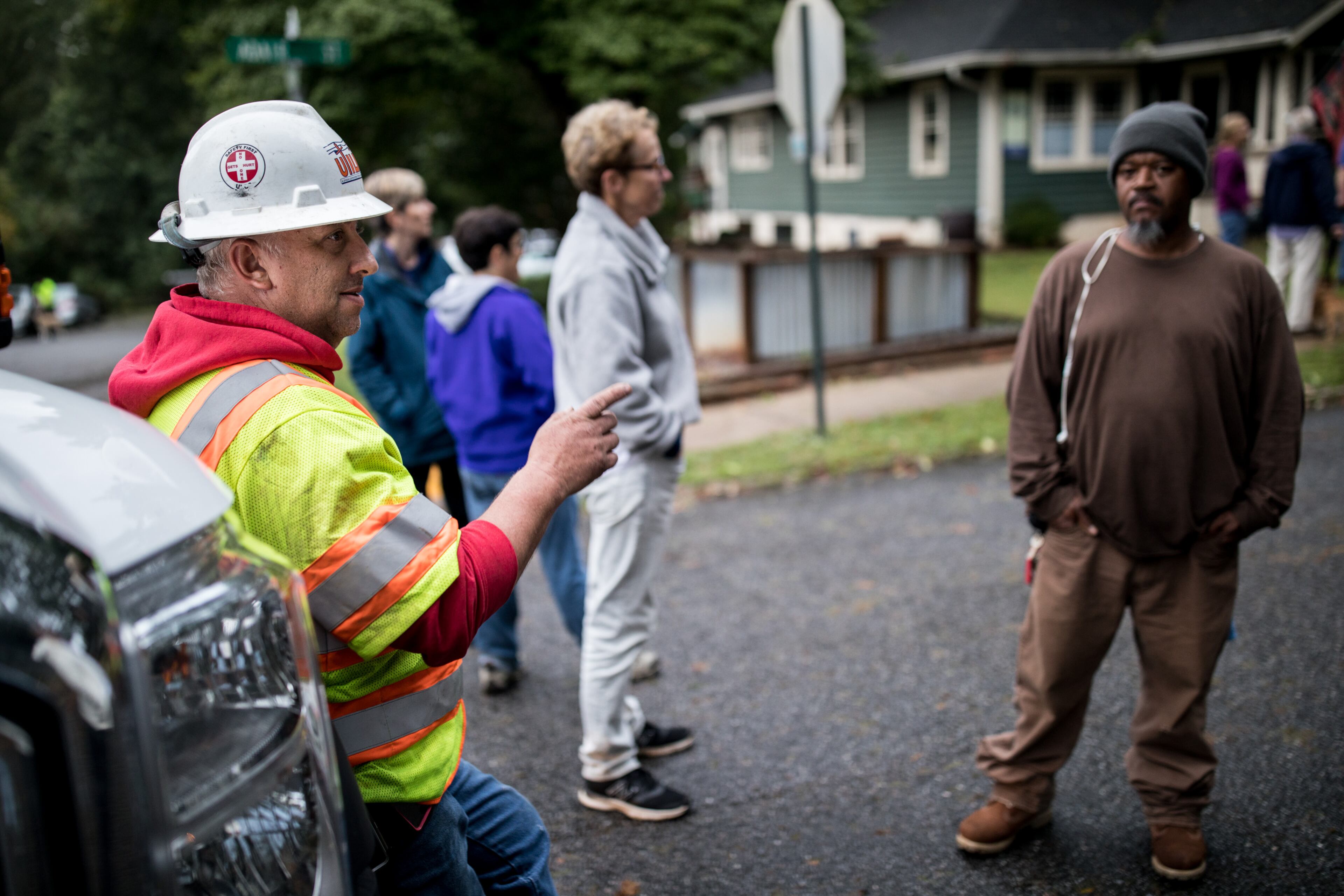 Utility Lines Construction Services employee Andy Hamilton, of Delaware, talks with residents as crews work to restore power on Adair Street, Tuesday, Sept. 12, 2017, in Decatur, Ga. BRANDEN CAMP/SPECIAL