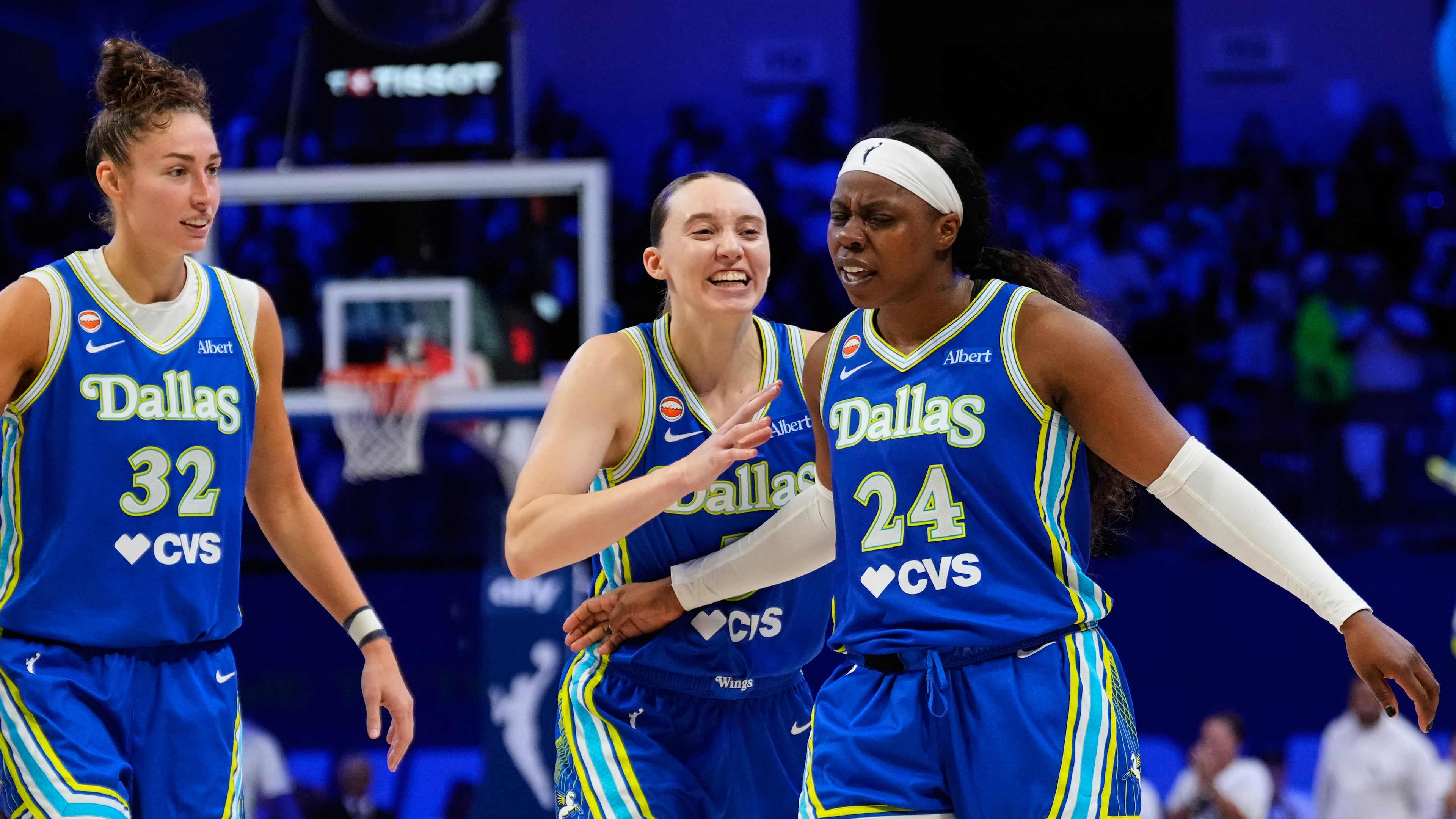 Dallas Wings' Jessica Shepard (32), Paige Bueckers (5) and Arike Ogunbowale (24) celebrate after Ogunbowale sunk a three-pointer in overtime of a WNBA basketball first-round playoff game against the Golden State Valkyries Wednesday Sept. 30, 2026, in Arlington, Texas. (AP Photo/Tony Gutierrez)