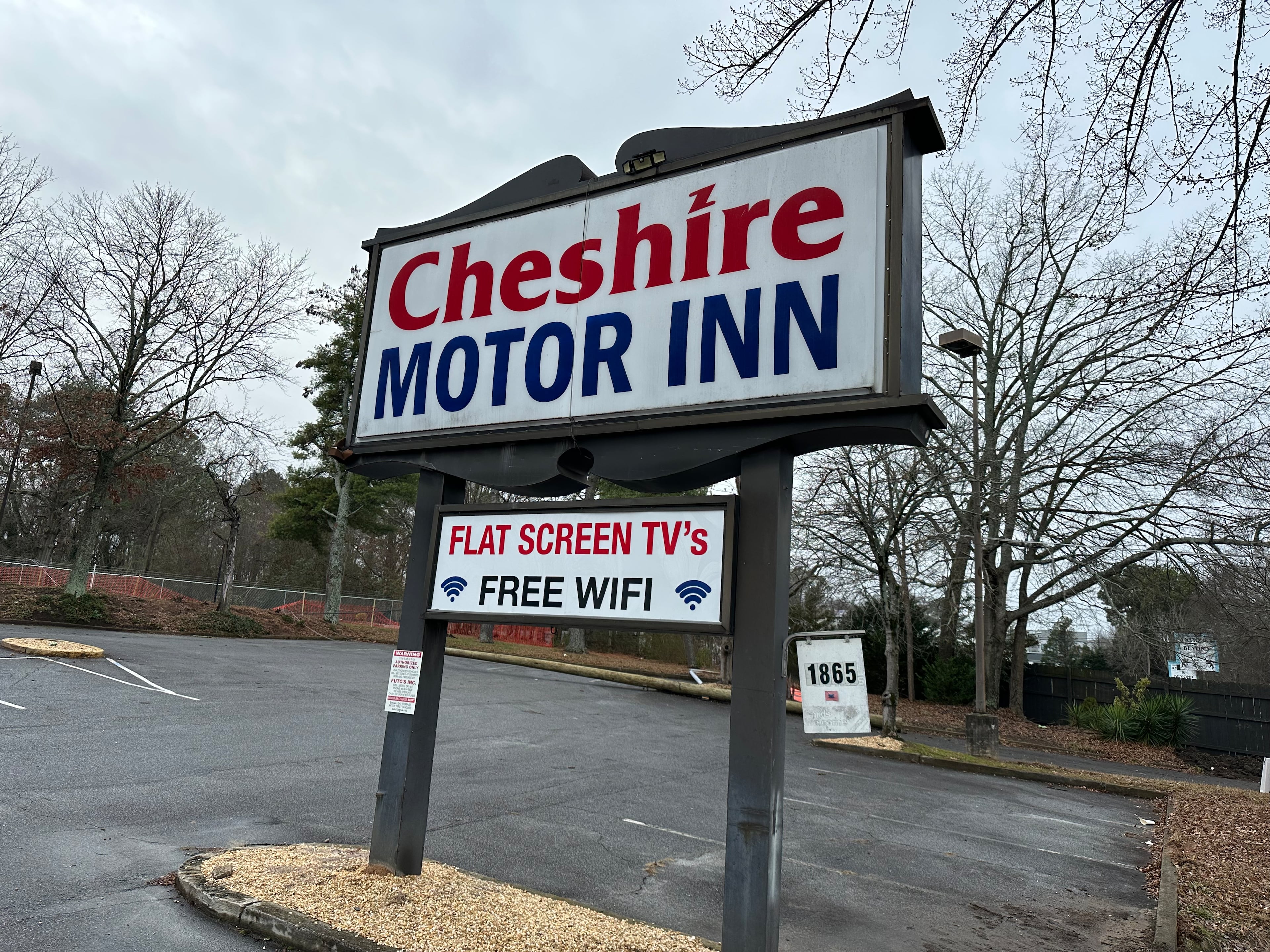 Cheshire Motor Inn opened in the late 1950s but closed in October 2025. The sign remains on Jan. 23, 2026, but the motel itself was already in rubble. (Rodney Ho/AJC)