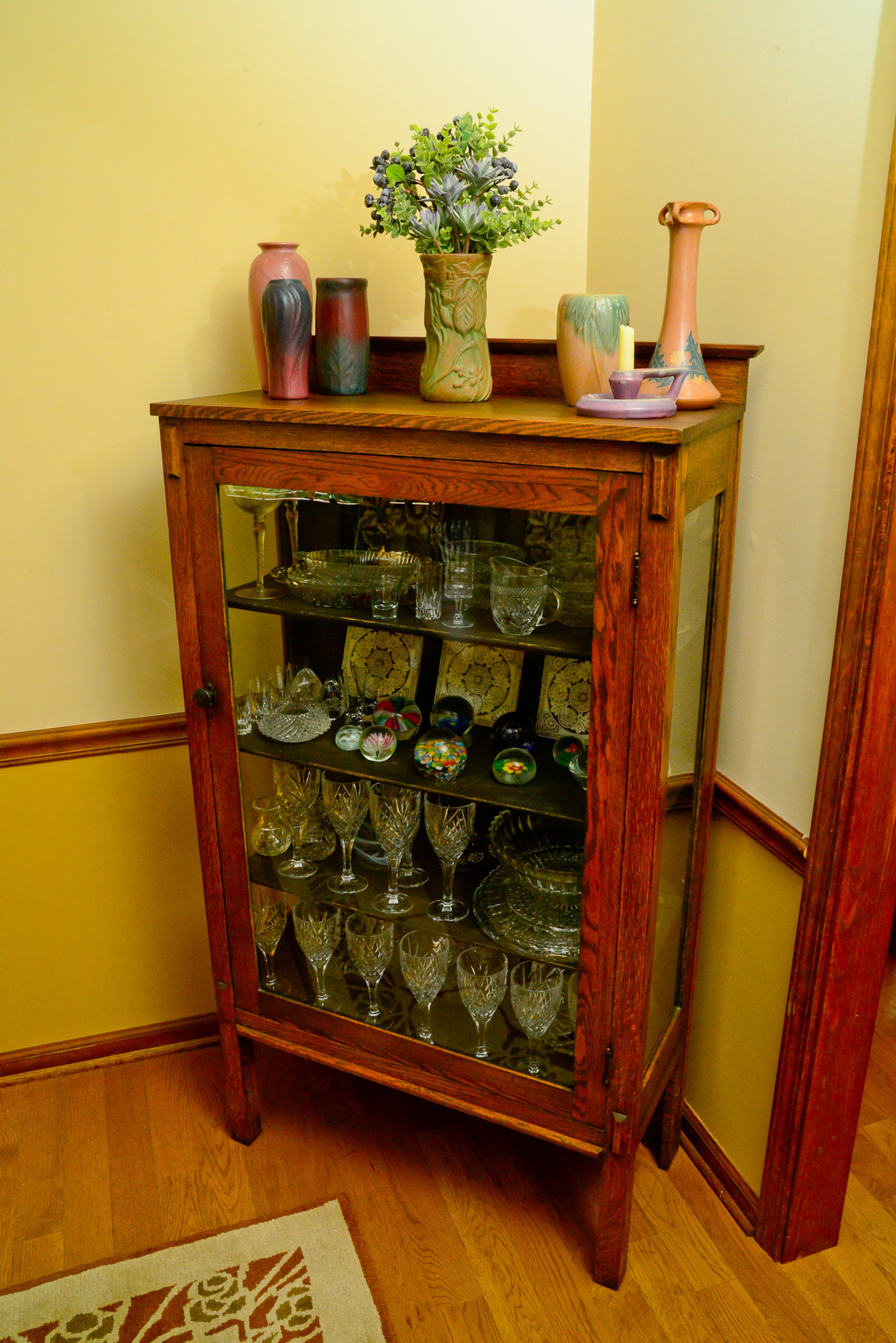 On an antique cabinet, art pottery features pieces from early 20th Century potteries, including Rookwood, Weller, Saturday Evening Girls, Roseville, Van Briggle, Marblehead, Hampshire, and Peters and Reed. All antique furniture and lighting were purchased from dealers at Scott Antique Market, at the National Arts & Crafts Conference in Asheville, N.C., or from various auctions.