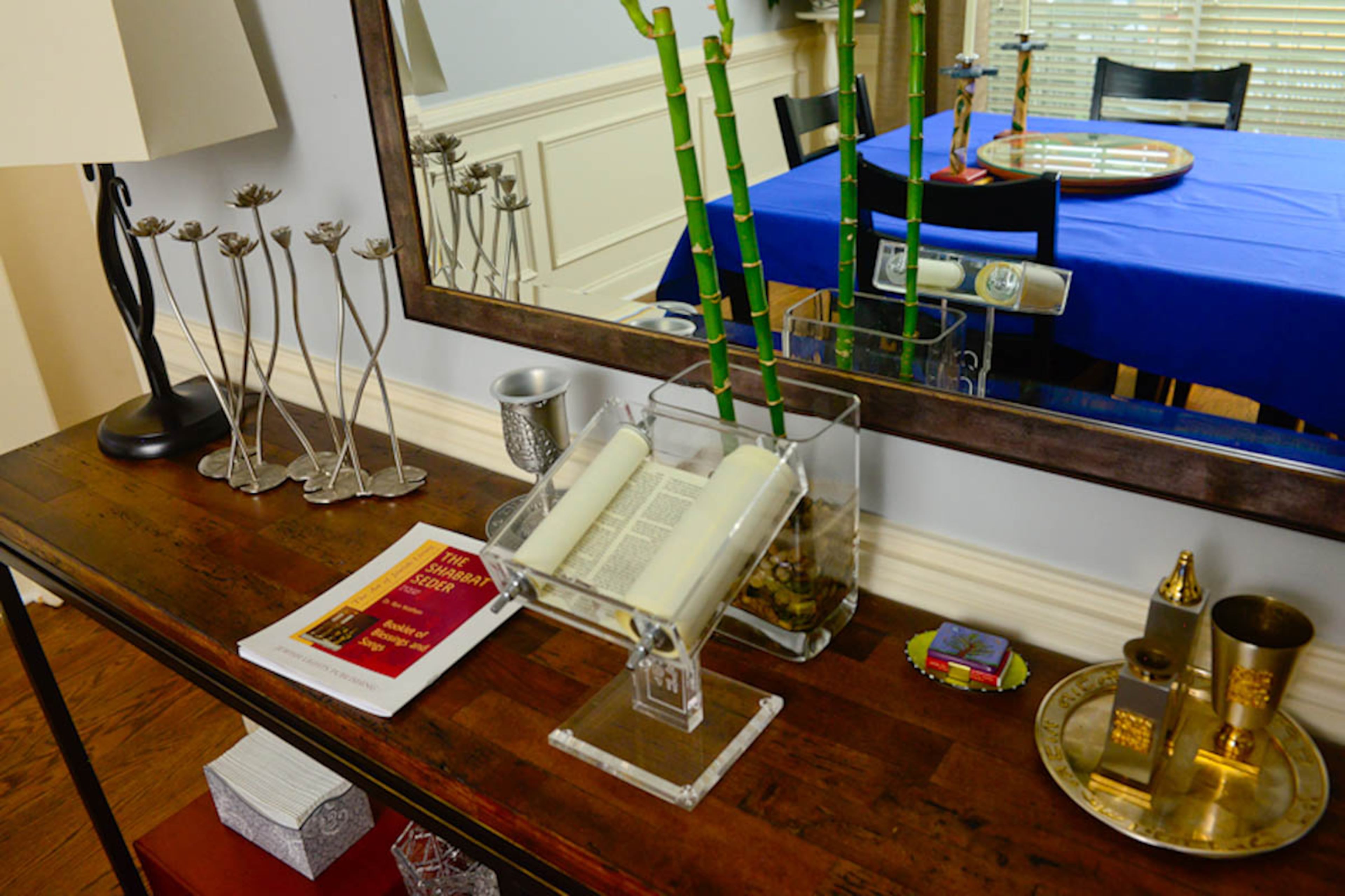 This console from Hooker Furniture holds treasured items, including a menorah, a kiddush cup, a havdalah set and a torah that was a gift from a neighbor.