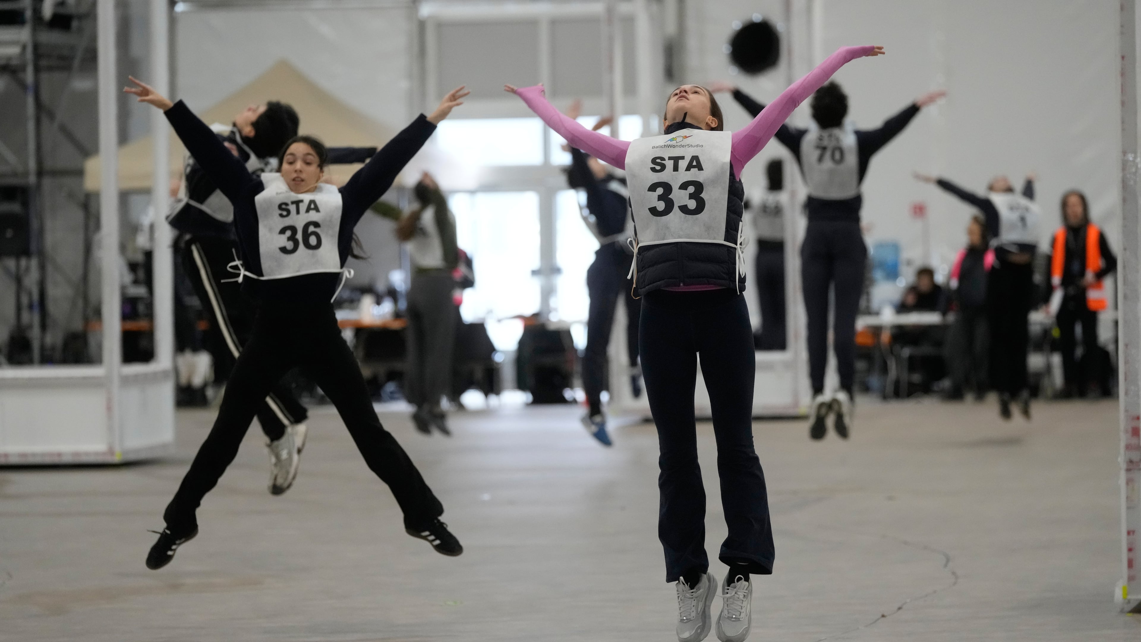 Volunteer dancers perform during rehearsals for the opening ceremony of the Milan Cortina 2026 Winter Olympic Games, at a compound in a big tent next to San Siro Stadium, in Milan, Italy, Saturday, Jan. 24, 2026. (AP Photo/Luca Bruno)