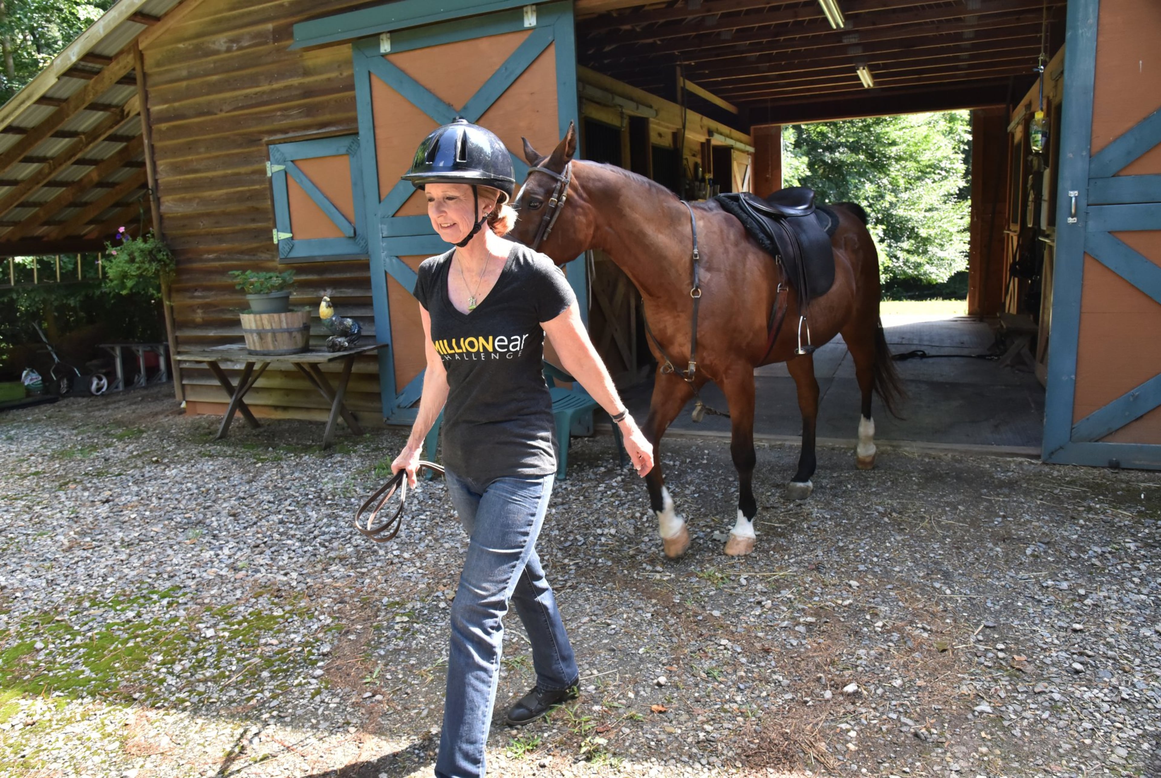 Robin Chisolm-Seymour prepares before she rides on her horse Jabez recently. As an equestrian, she won championships, but when she started losing her hearing, it affected her balance, and she had to make adjustments to return to horseback riding. HYOSUB SHIN / HSHIN@AJC.COM