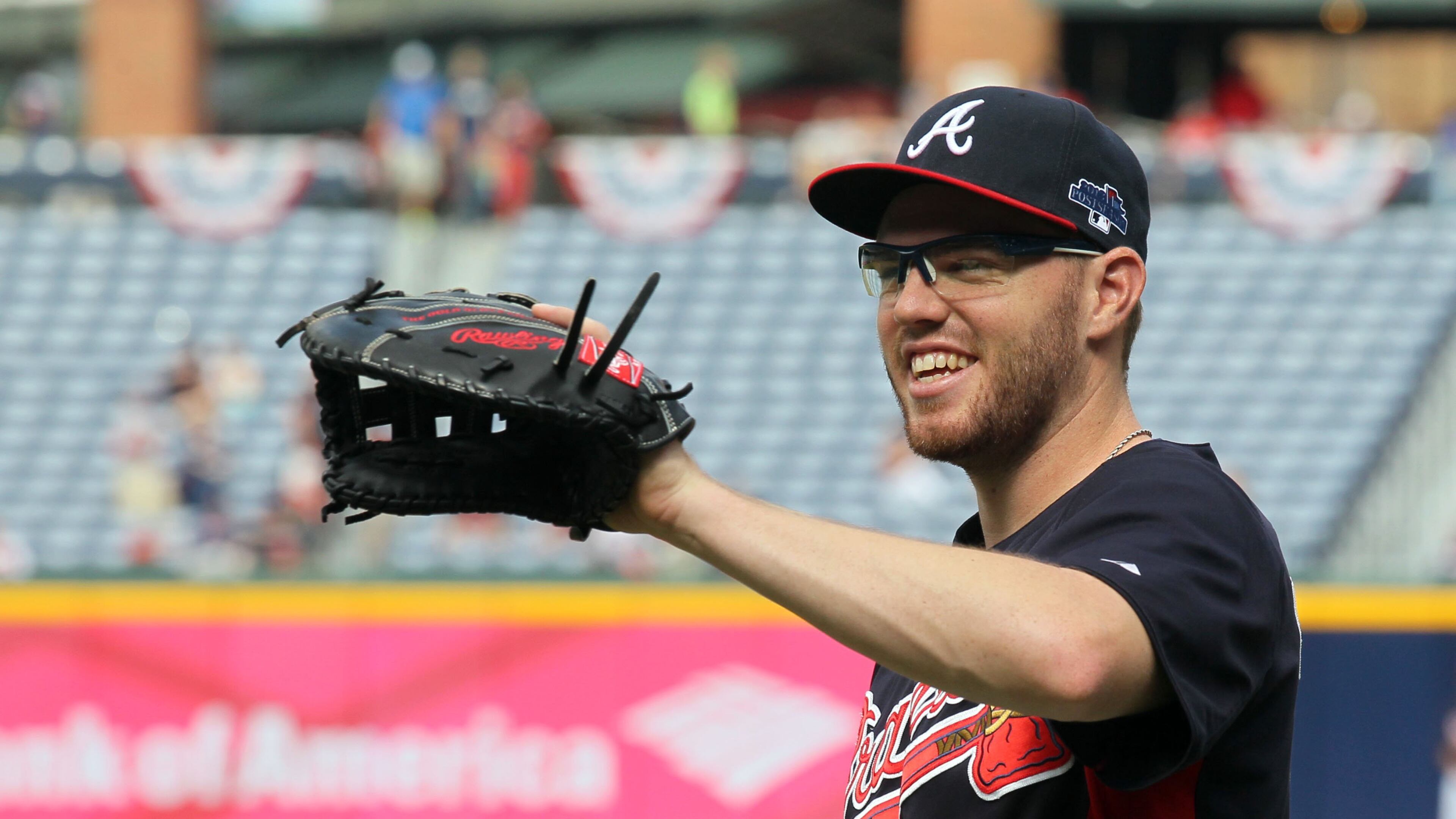 Atlanta Braves first baseman Freddie Freeman (5) fields during batting practice before the second game of the National League Division series between the Los Angeles Dodgers and Atlanta Braves at Turner Field, Friday, October 4, 2013.