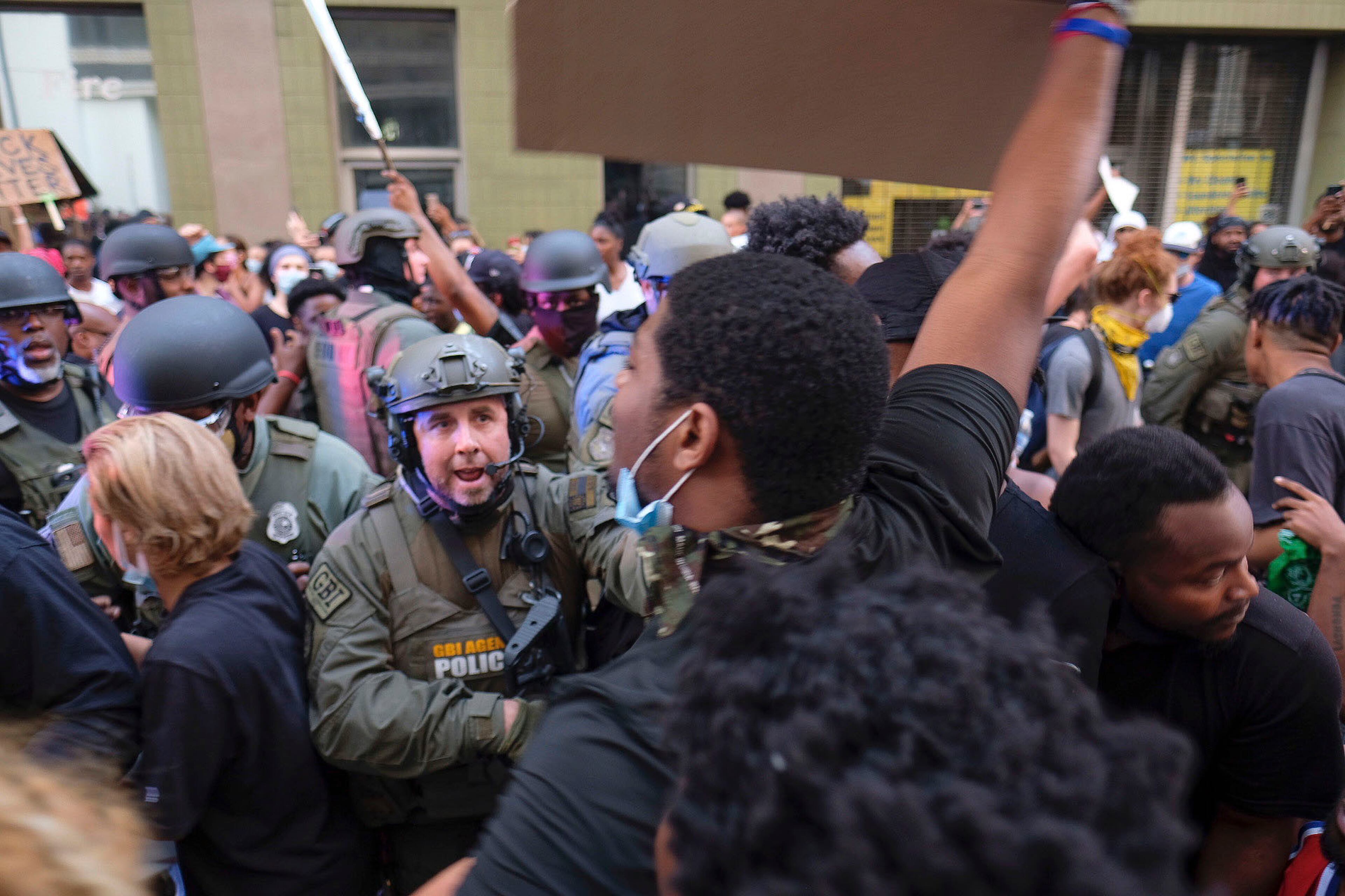 June 2, 2020 - Atlanta - Tense stand-off after homeland security officers took a protester into custody. They had to bring in a team of officers to extract the car. Could have been really bad, but the guy in yellow helped keep the crowd back a bit, and the officers did not escalate, even though they had to pull people out of the cars path Protestors in downtown Atlanta as protests continued for a fourth day. Protests over the death of George Floyd in Minneapolis police custody continued around the United States, as his case renewed anger about others involving African Americans, police and race relations. Ben Gray for the Atlanta Journal Constitution