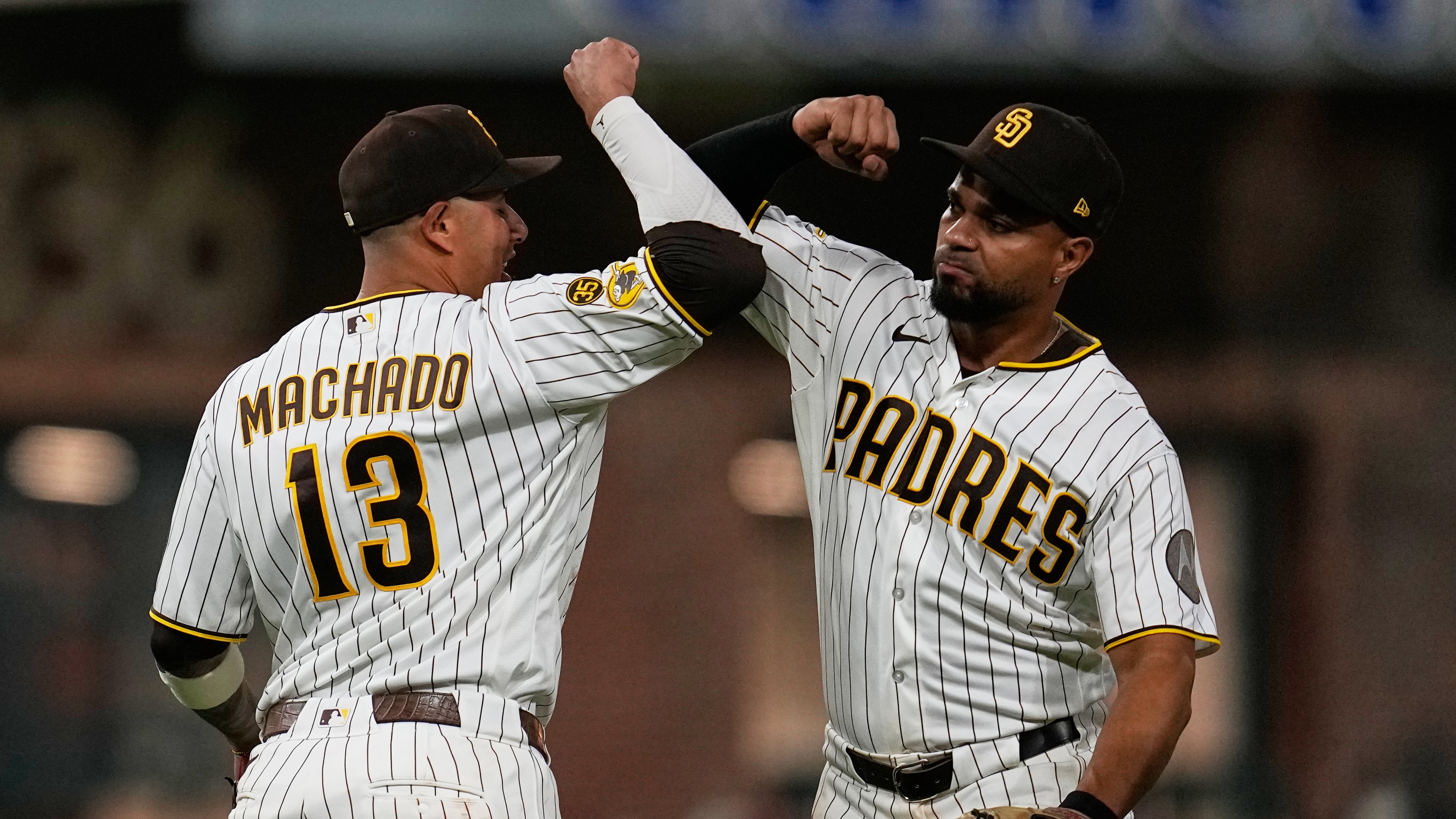 San Diego Padres third baseman Manny Machado (13) celebrates with shortstop Xander Bogaerts after the Padres defeated the Atlanta Braves 1-0 in a baseball game Monday, June 22, 2026, in San Diego. (AP Photo/Gregory Bull)