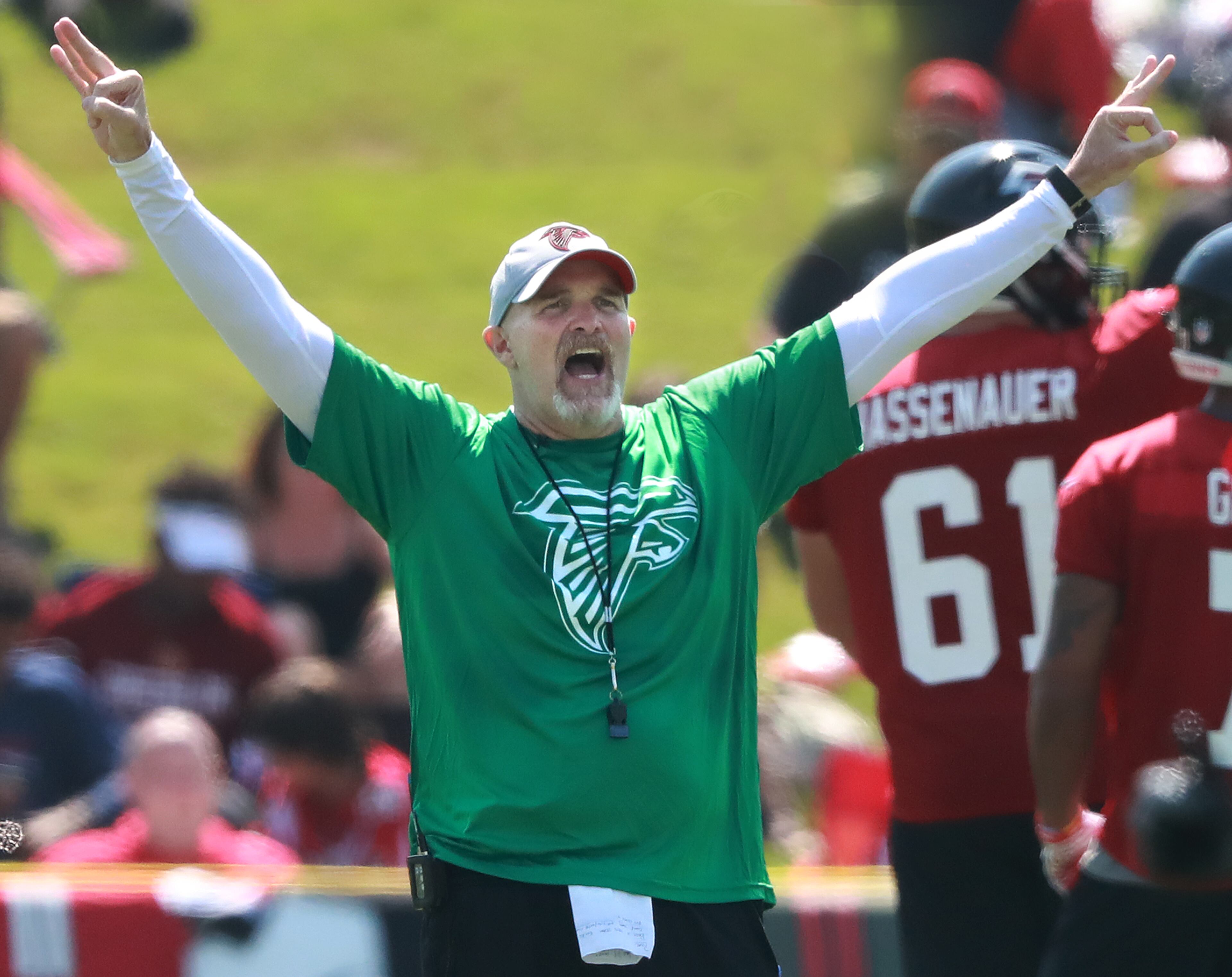 Falcons head coach Dan Quinn keeps his team moving the opening day of training camp on Friday, July 27, 2018, in Flowery Branch. Curtis Compton/ccompton@ajc.com