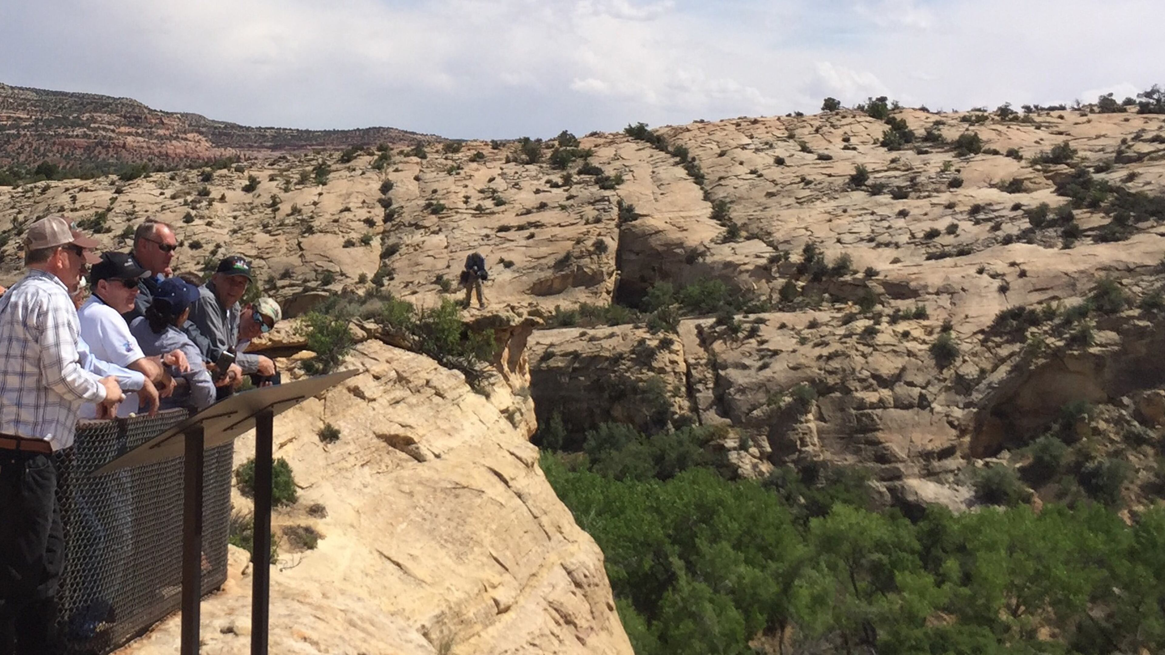 Interior Secretary Ryan Zinke, hatless and wearing sunglasses, looks at ancient native ruins in Bears Ears National Monument, Utah. (William Yardley/Los Angeles Times/TNS)