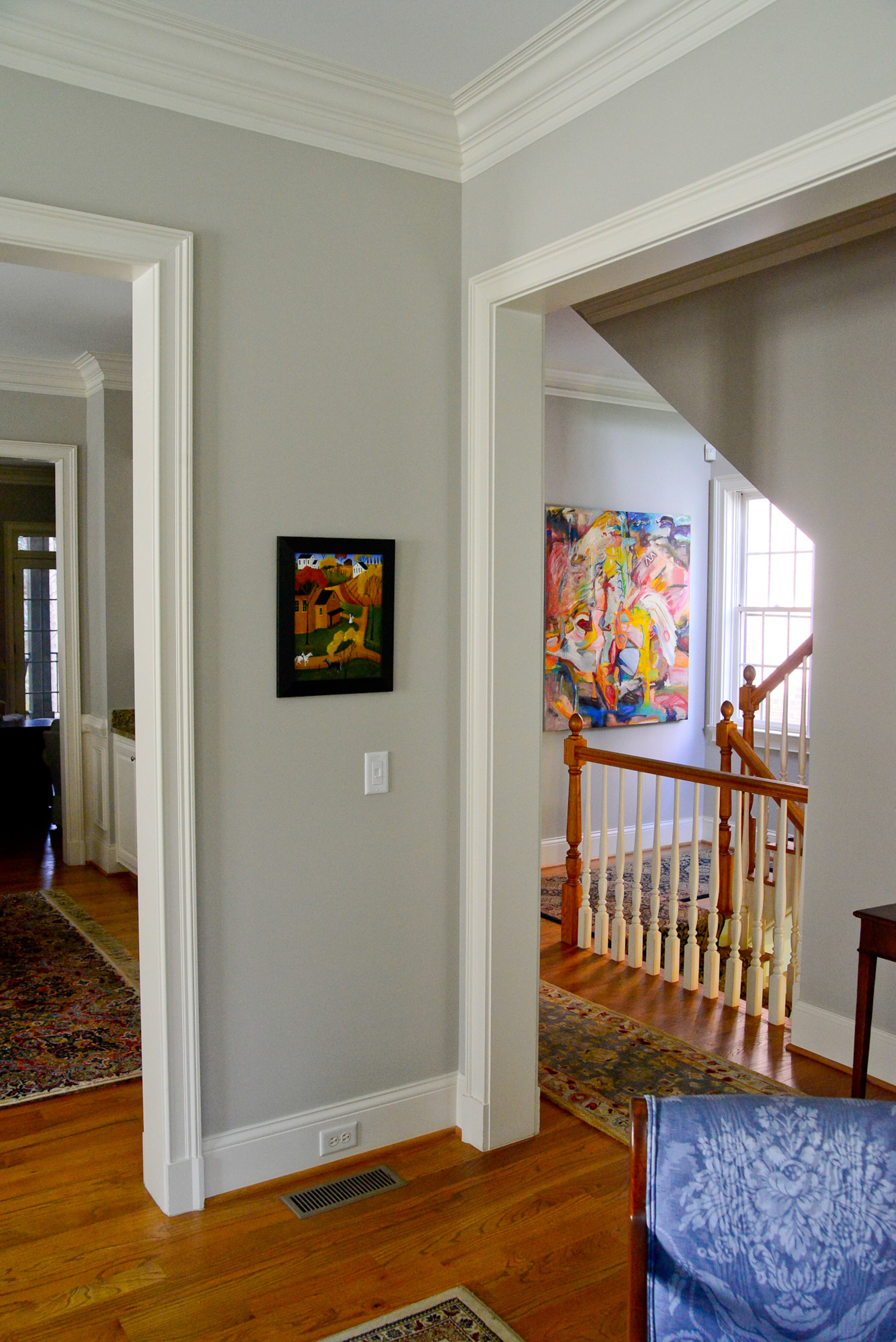 The homeowners tried many samples of gray for the main wall color, but the hue changed in different areas of the home, depending on the light. They finally chose Revere Pewter by Benjamin Moore, which is on all four floors and provides a backdrop to their art collection.
