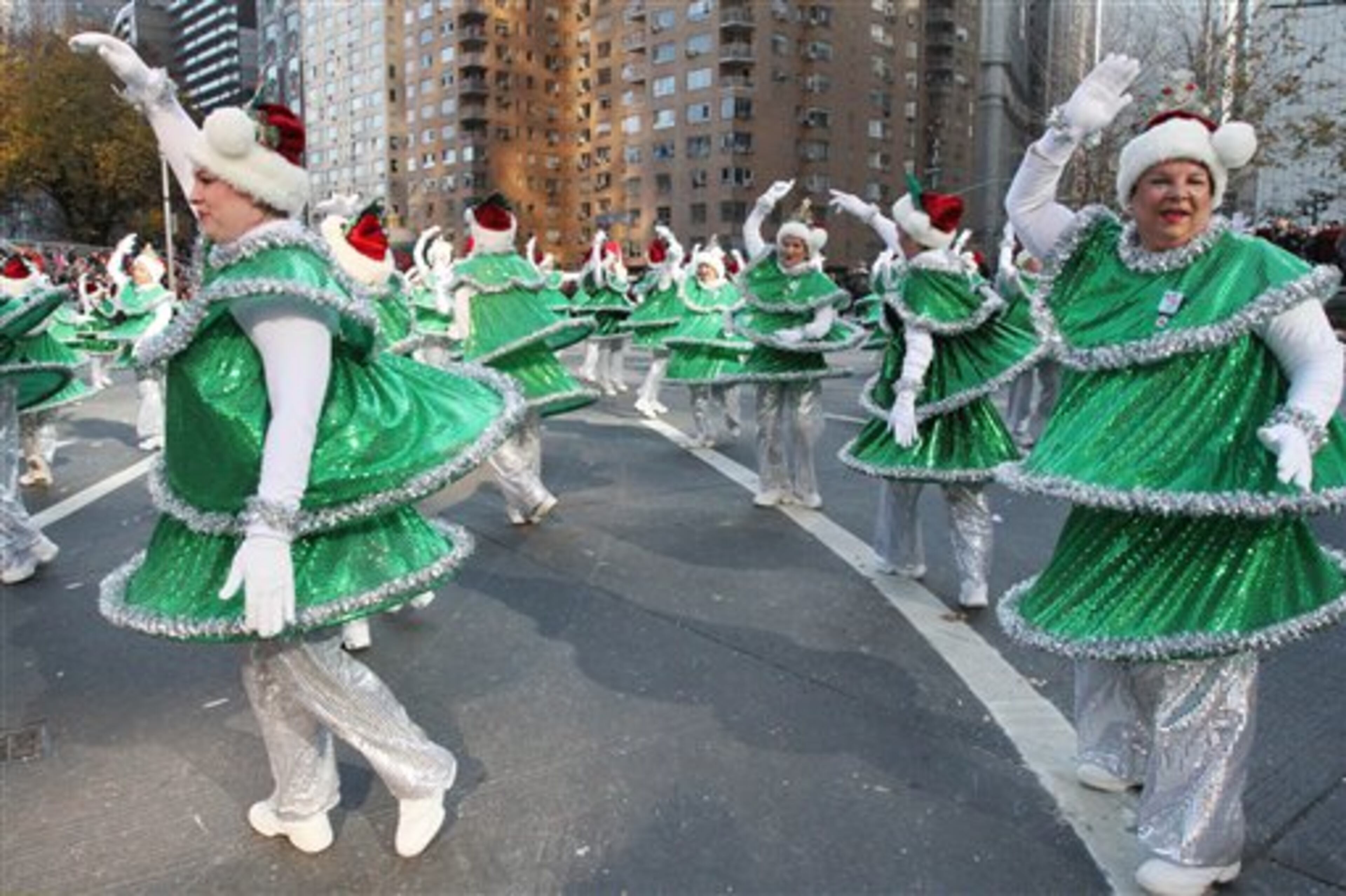 The Tap Dancing Christmas Trees make their way through New York's Columbus Circle during the 86th Annual Macy's Thanksgiving Day Parade, Thursday Nov. 22, 2012, in New York. The annual Macy's Thanksgiving Day Parade put a festive mood in the air in a city still coping with the aftermath of Superstorm Sandy. (AP Photo/Tina Fineberg)