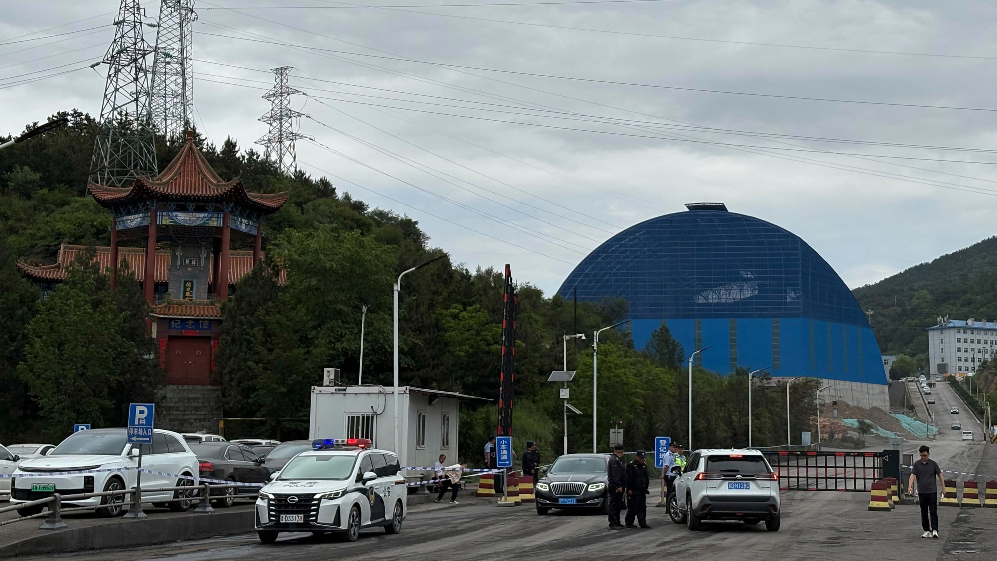 Police officers at a checkpoint stop cars at the entrance to the Liushenyu coal mine facility in Qinyuan county in Changzhi, northern China's Shanxi province on Sunday, May 24, 2026. (AP Photo/E. Eduardo Castillo)