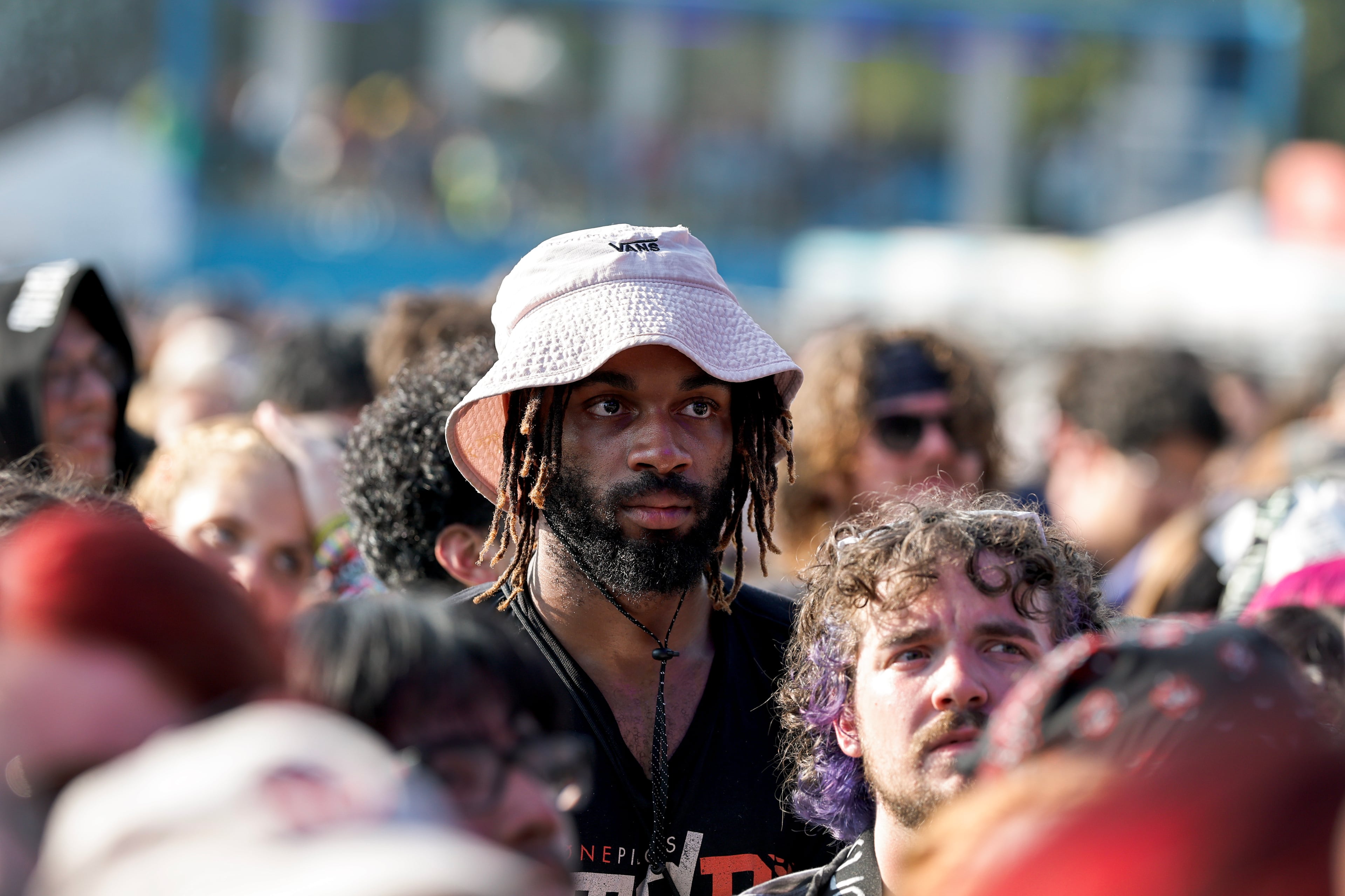A fan listens to Peach Pit perform during the Shaky Knees music festival at Piedmont Park, Saturday, Sept. 19, 2026, in Atlanta. (Erik S. Lesser for the AJC)