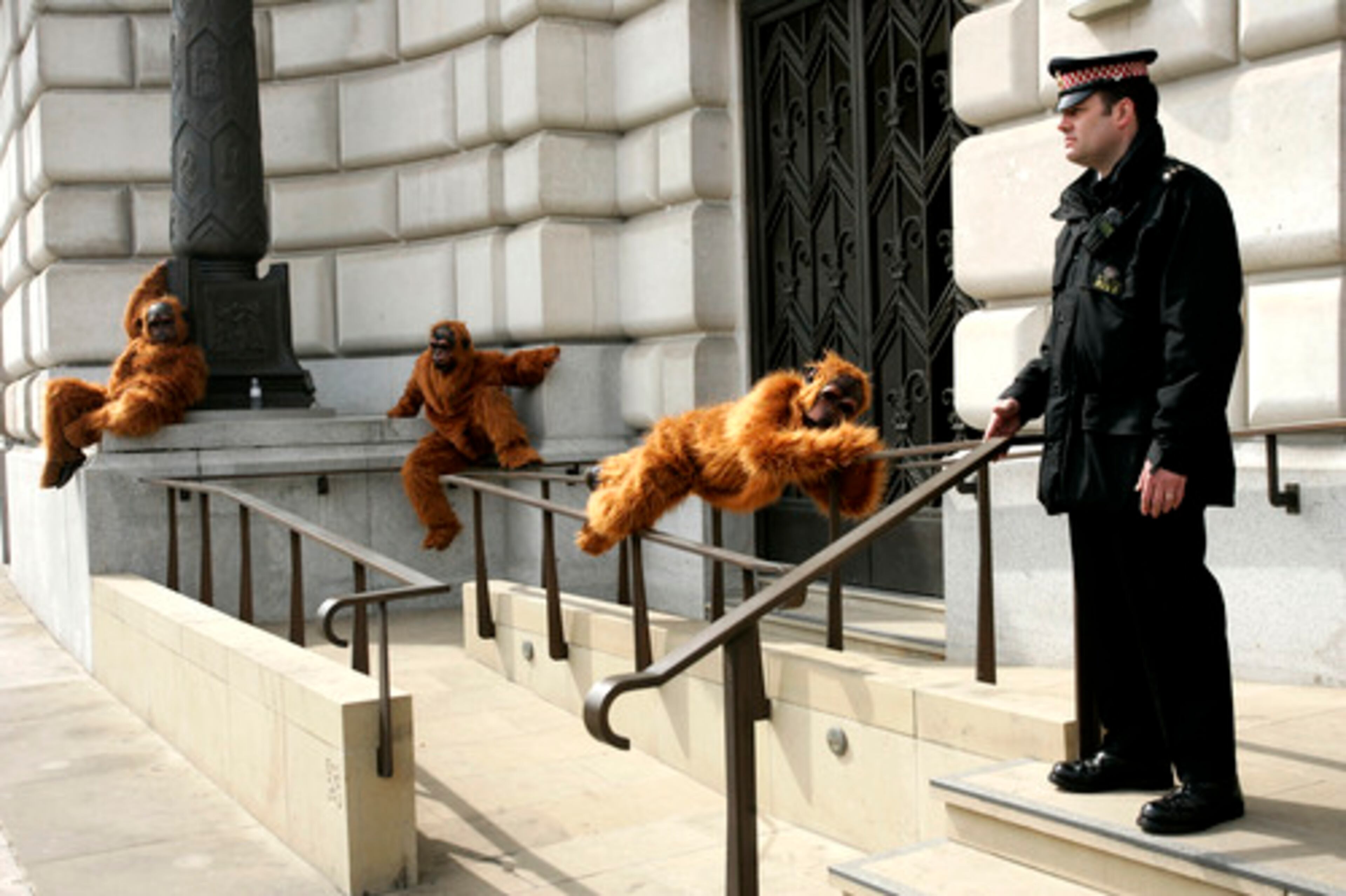 Protesters from Greenpeace, dressed as orangutans, demonstrate outside the Unilever office in London on Monday as a policeman looks on. Greenpeace called for a moratorium on the expansion of palm oil plantations in Indonesia rainforests, where orangs are typically found.