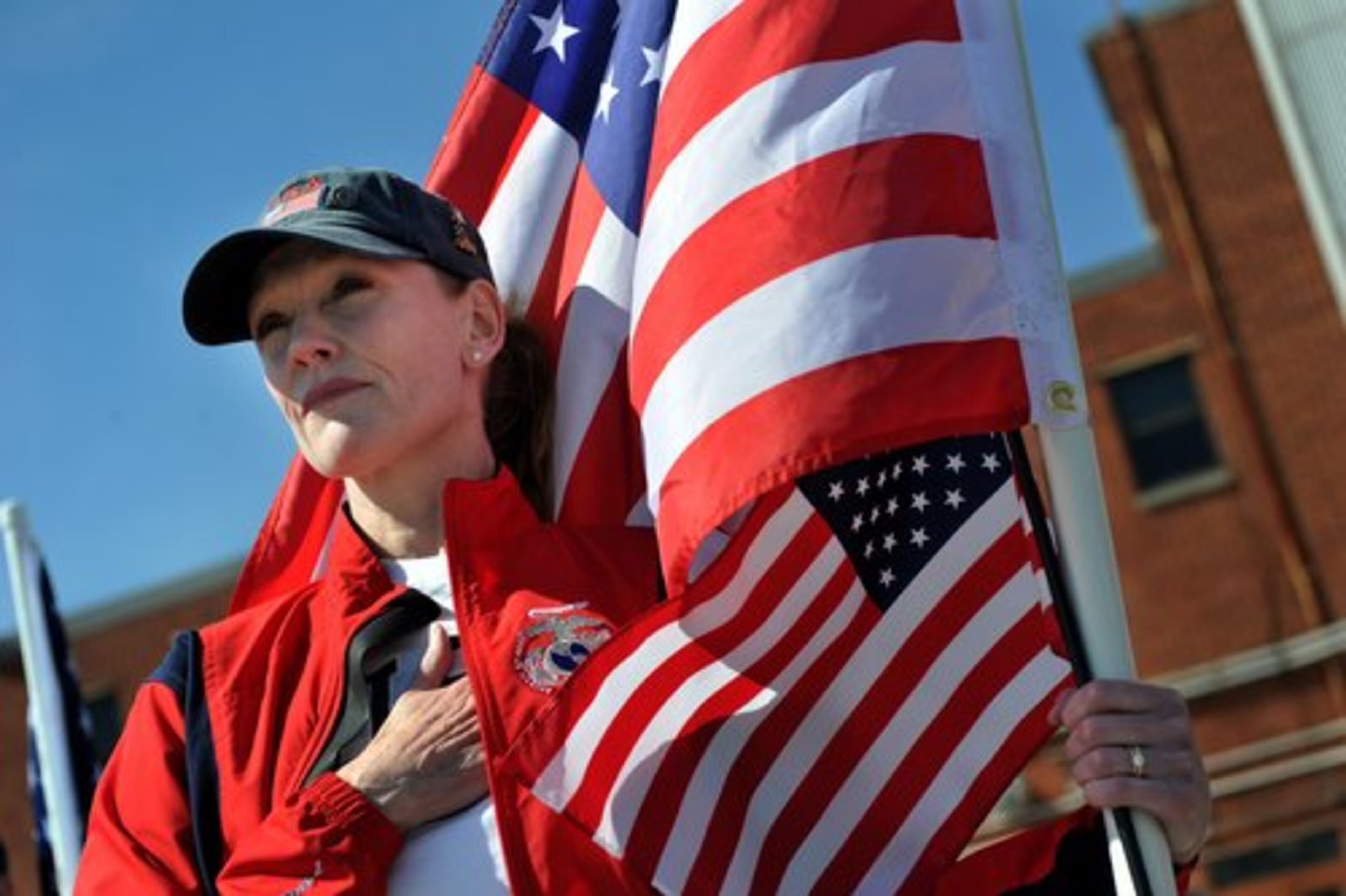 A woman, who preferred to not give her name, watches as the jet carrying the body of Jason H. Estopinal, arrives at Dobbins Air Reserve Base.