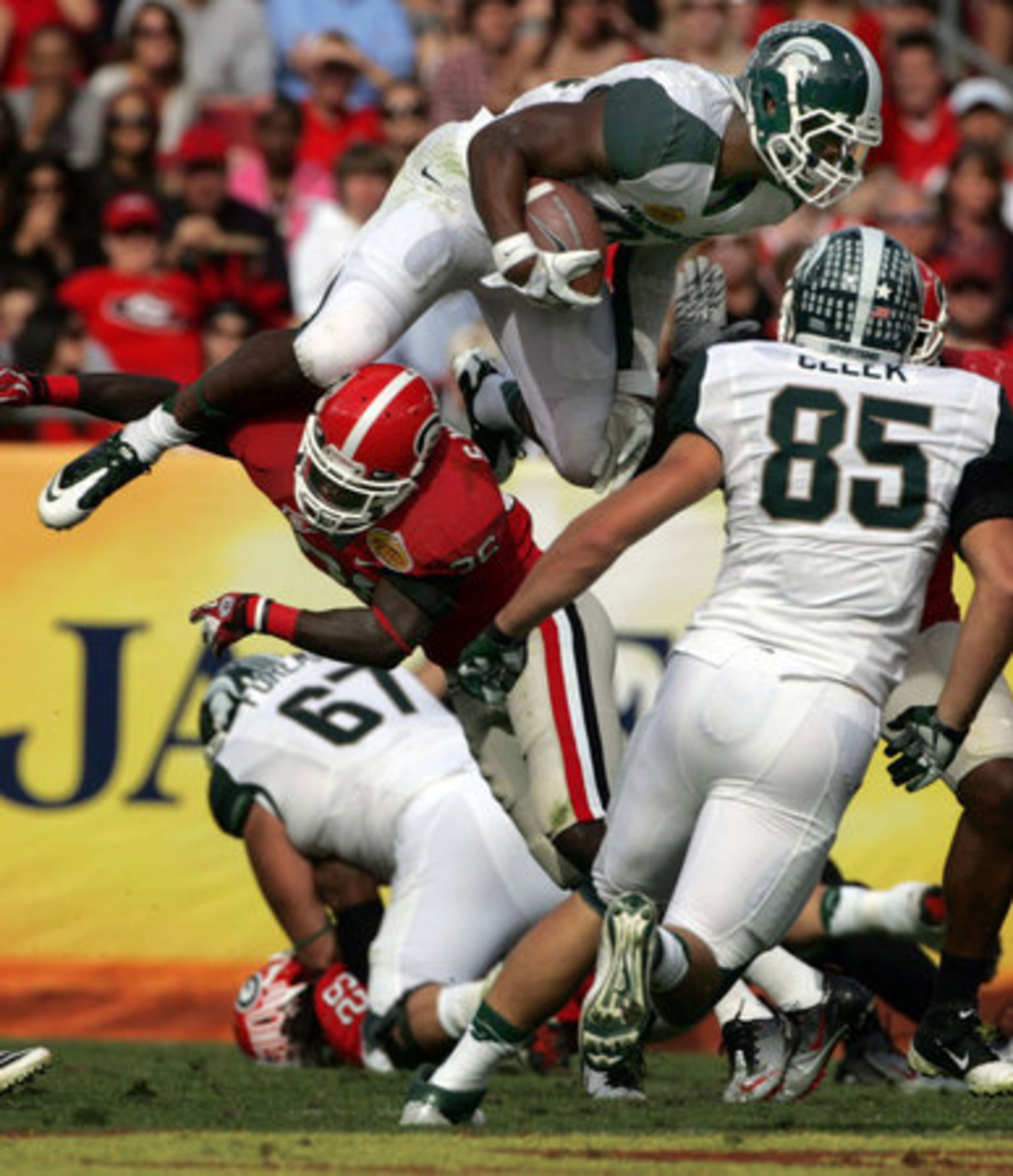 Michigan State University's Le'Veon Bell leaps over the Georgia defense for a short gain during second-quarter action at the the Outback Bowl.