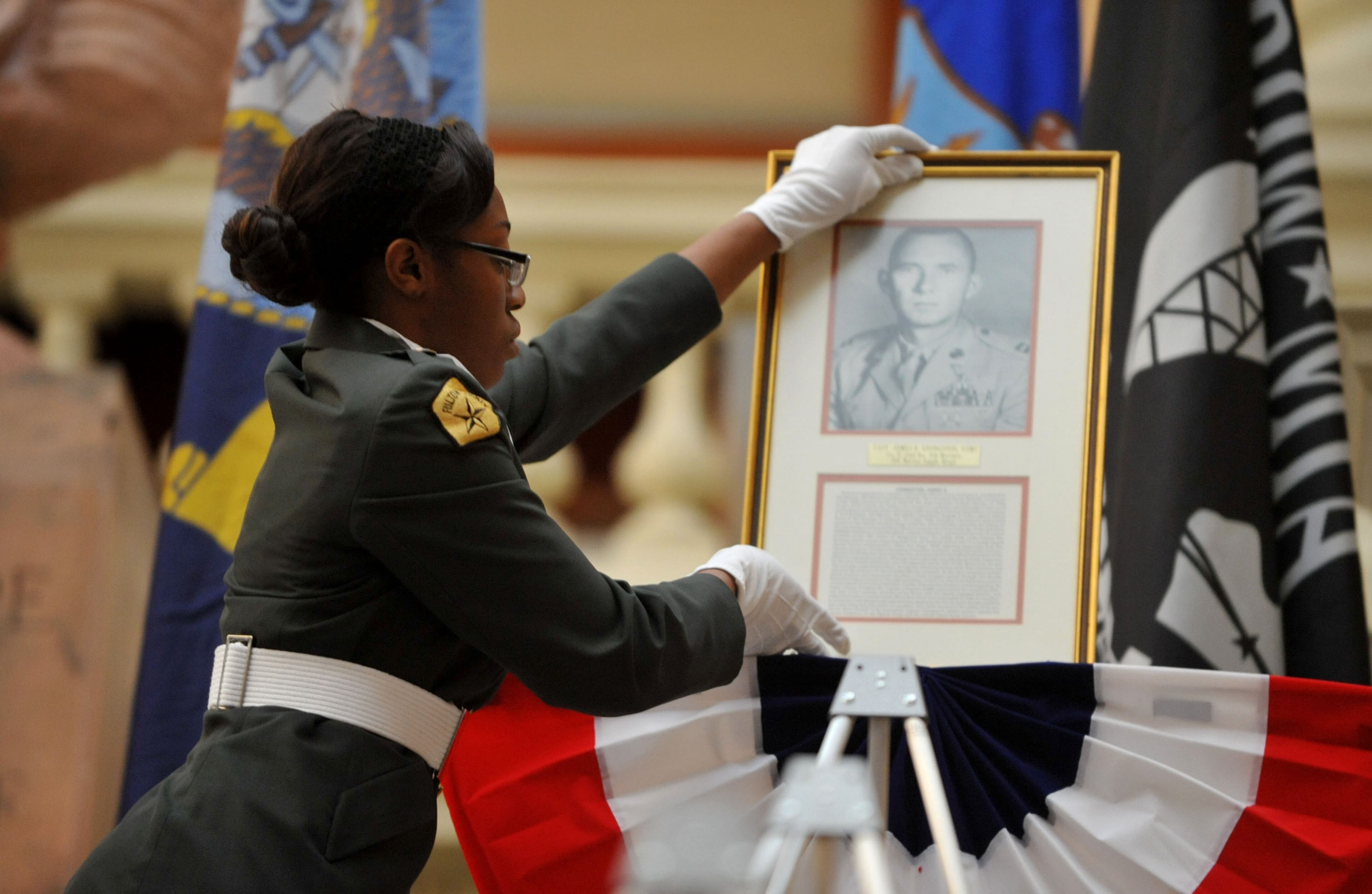 Westlake HS Army JROTC member Naomi Gordon, places the portrait of Capt James Livingston, USMC, on the steps of the Capitol. Major General Livingston (Ret.), gave remarks during the ceremony. Veterans, family members and state officials attend a ceremony honoring Medal of Honor recipients from the Vietnam War at the Georgia Capitol Tuesday, March 25, 2014. Twelve Georgians, veterans of the Vietnam War, possess the Medal of Honor. It is the highest accolade this nation gives its warriors. On Tuesday, they were recognized in a special ceremony at the Capitol. Gov. Nathan Deal proclaimed March 29 as Vietnam Veterans Day in Georgia. KENT D. JOHNSON / KDJOHNSON@AJC.COM