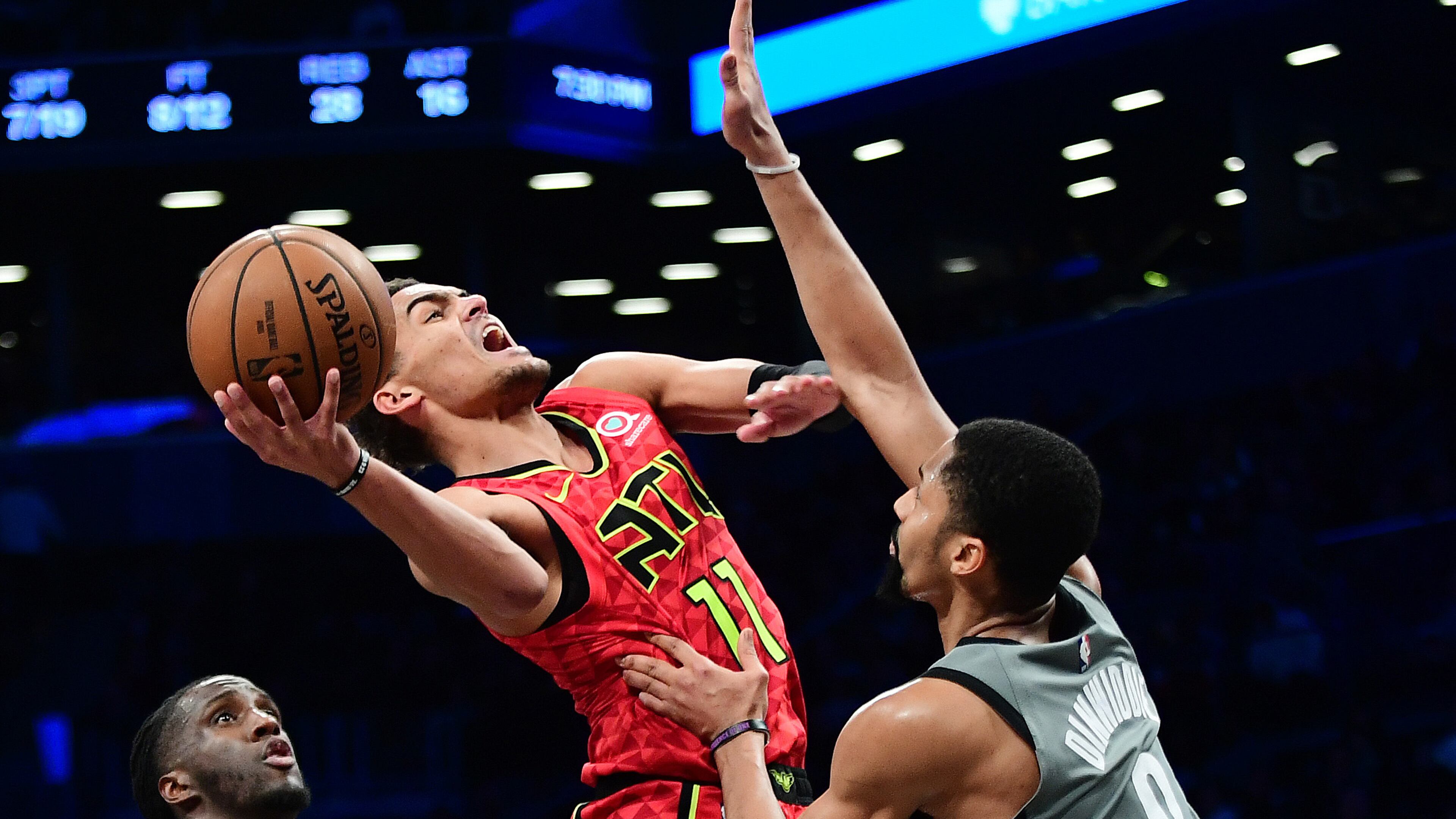 Hawks guard Trae Young is fouled by the Nets' Spencer Dinwiddie during the second half Saturday, Dec. 21, 2019, at Barclays Center in New York.