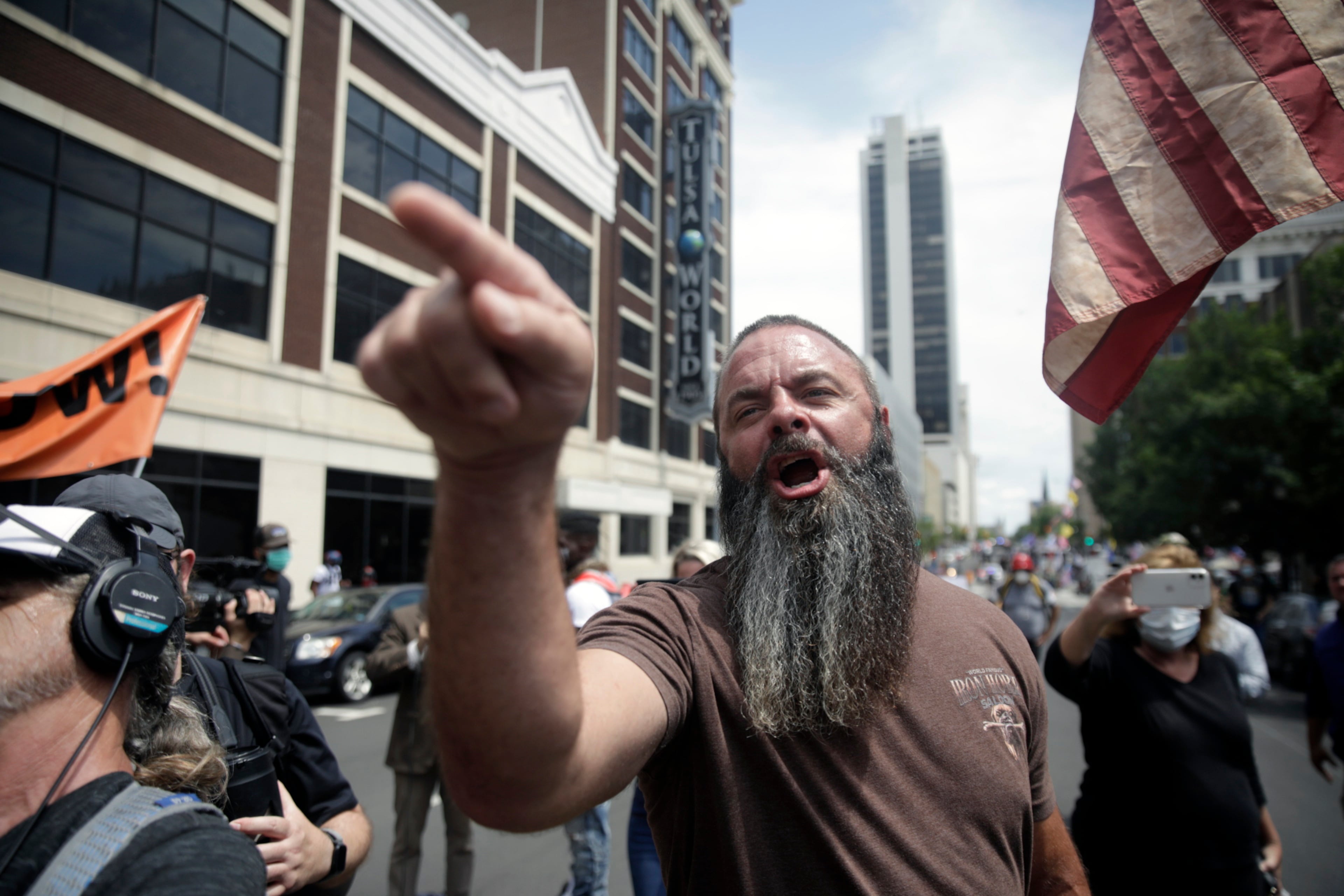 Trump supporters and opponents clash at Fourth and Denver a few blocks away from the BOK Center before President Trump's planned rally, Saturday, June 20, 2020 in Tulsa, Okla. (Mike Simons/Tulsa World via AP)