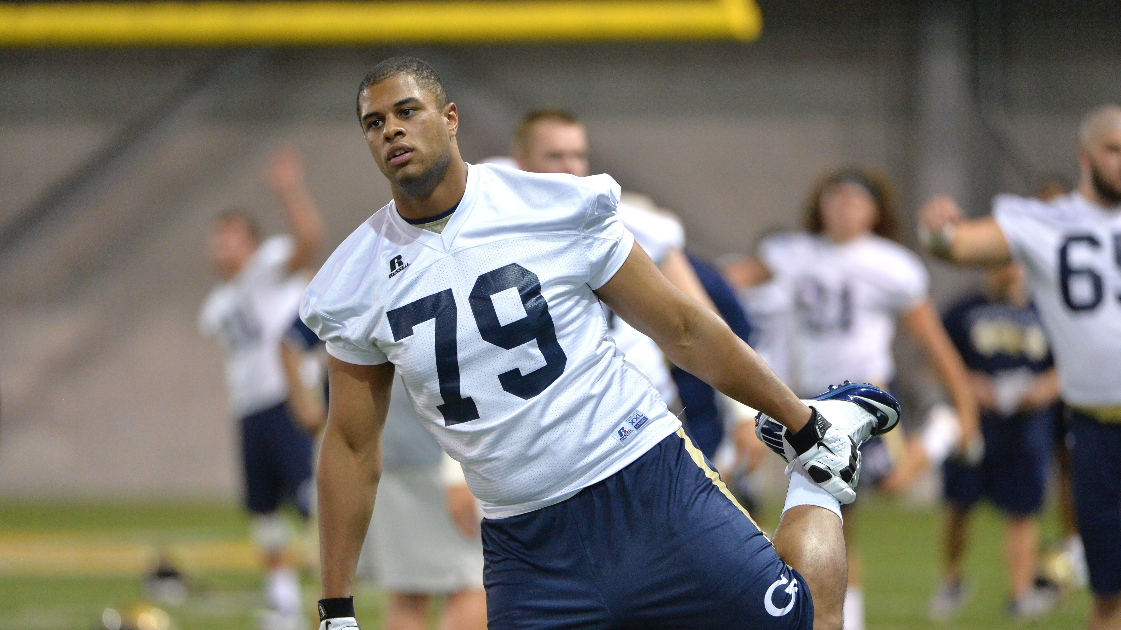 Georgia Tech Yellow Jackets offensive lineman Eason Fromayan (79) and other players warm up during the first day of practice at Rose Bowl Field in Georgia Tech campus on Thursday, August 4, 2016. HYOSUB SHIN / HSHIN@AJC.COM