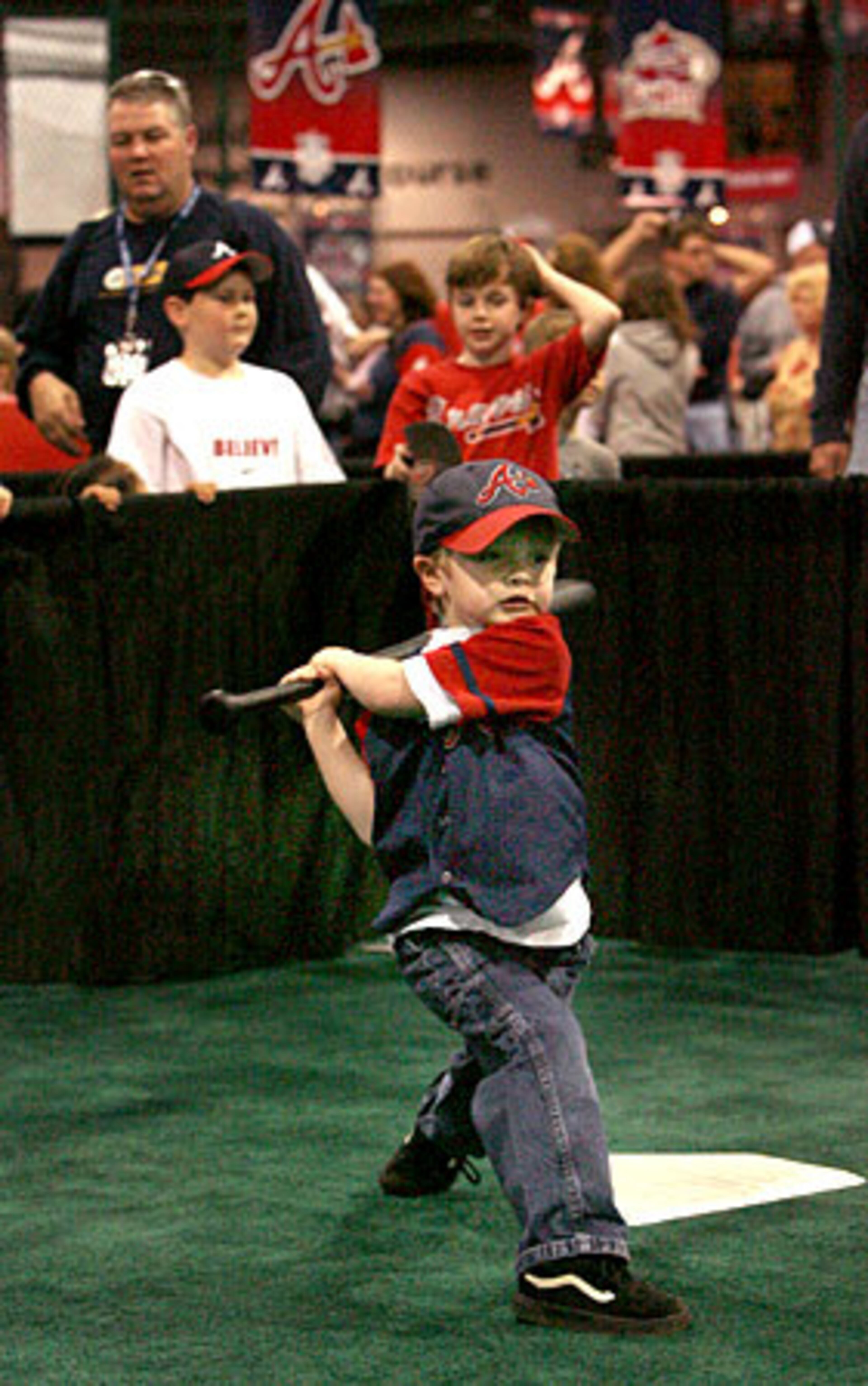 Kyle Kunberger swings the bat at the Braves FanFest. Fans were treated to baseball clinics, pitching and hitting drills as well as the opportunity to purchase baseball items.