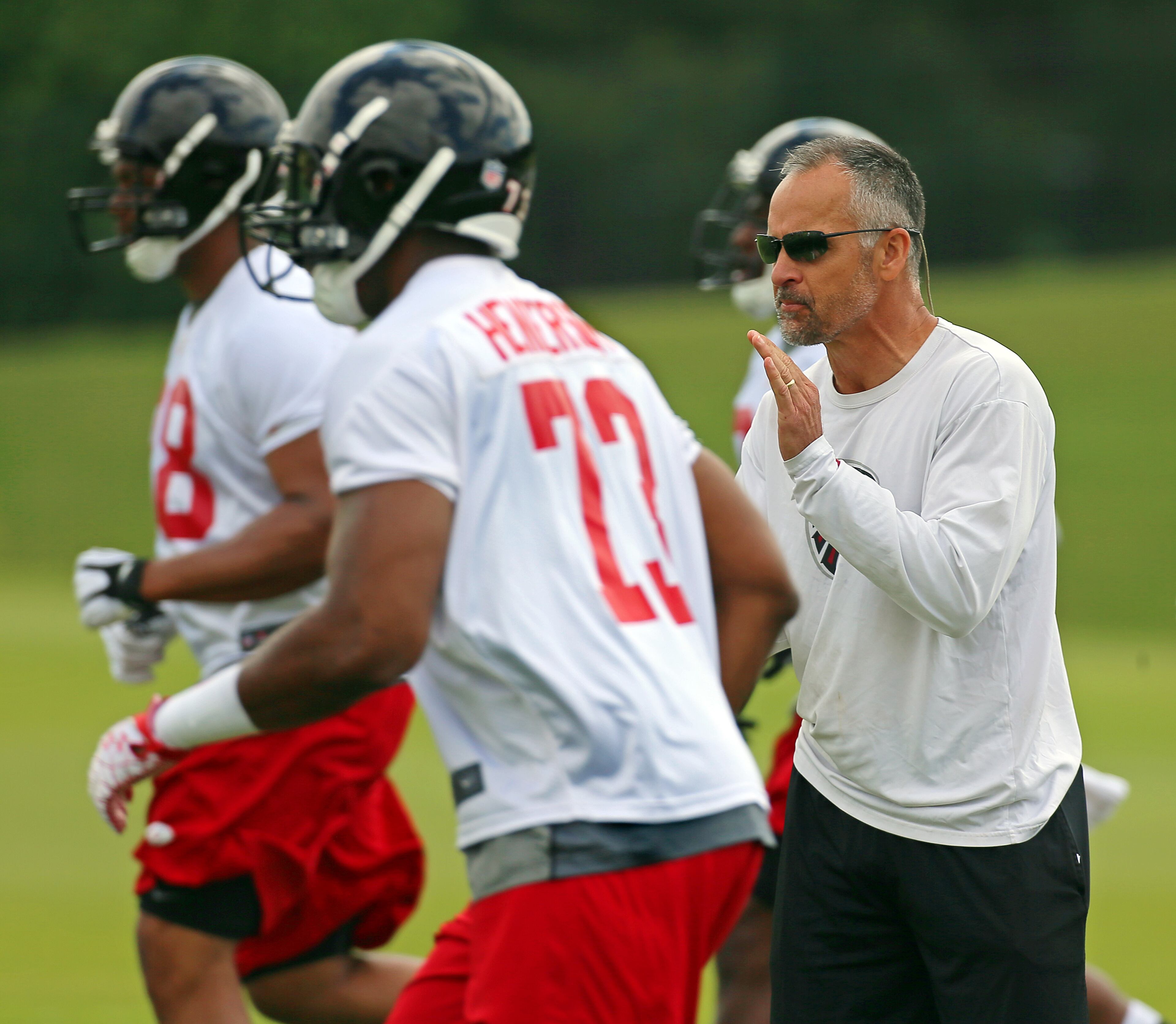 Falcons defensive coordinator Mike Nolan keeps his players on the move during drills at team practice on Wednesday, May 29, 2013, in Flowery Branch. CURTIS COMPTON / CCOMPTON@AJC.COM