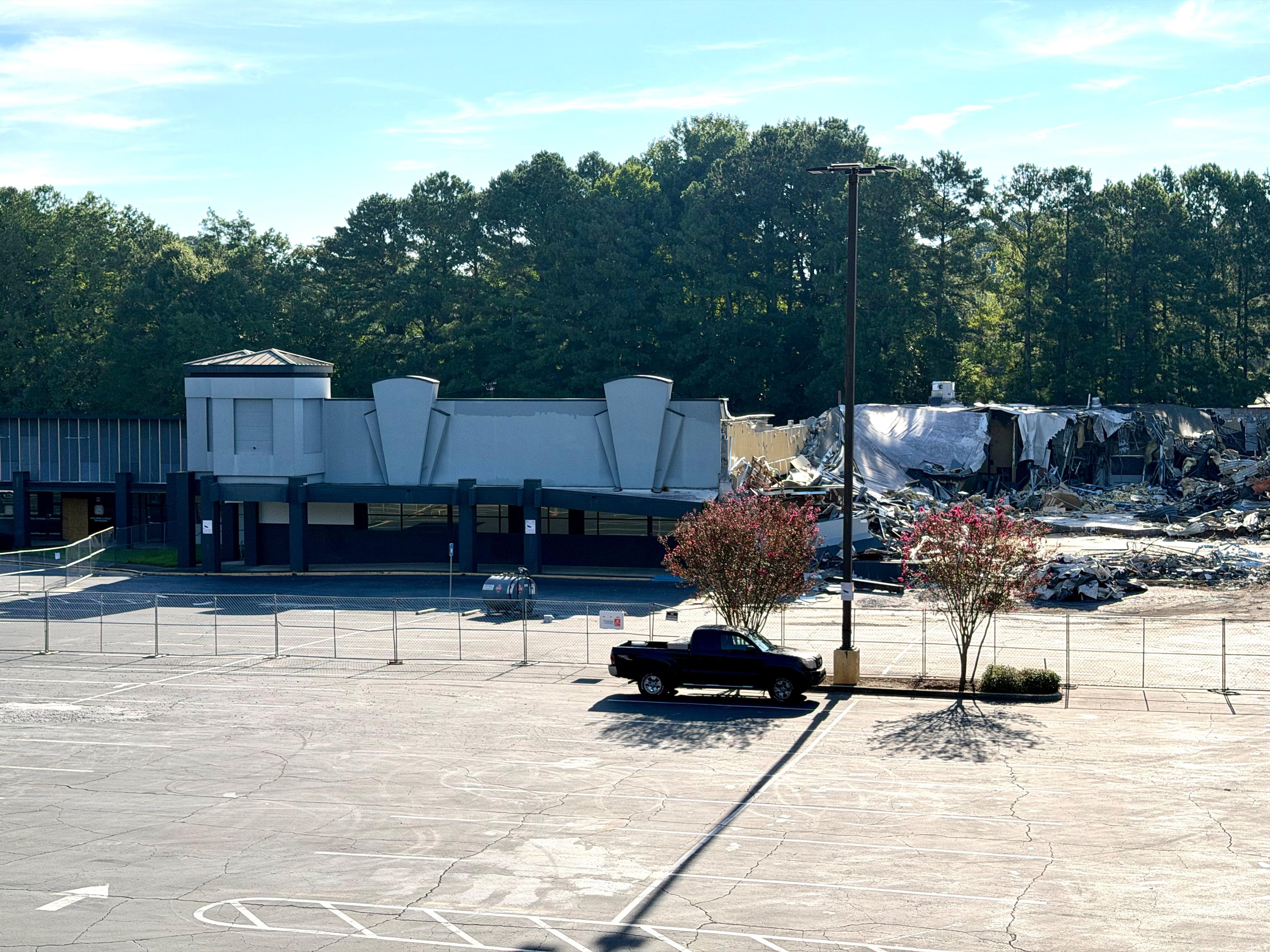 Crews work to demolish a former bowling alley in the North River Shopping Center on Wednesday, Aug. 19, 2026, in Sandy Springs. Built in the late 1970s, the strip mall has spent most of the past decade more than half empty. (J. Scott Trubey/AJC)