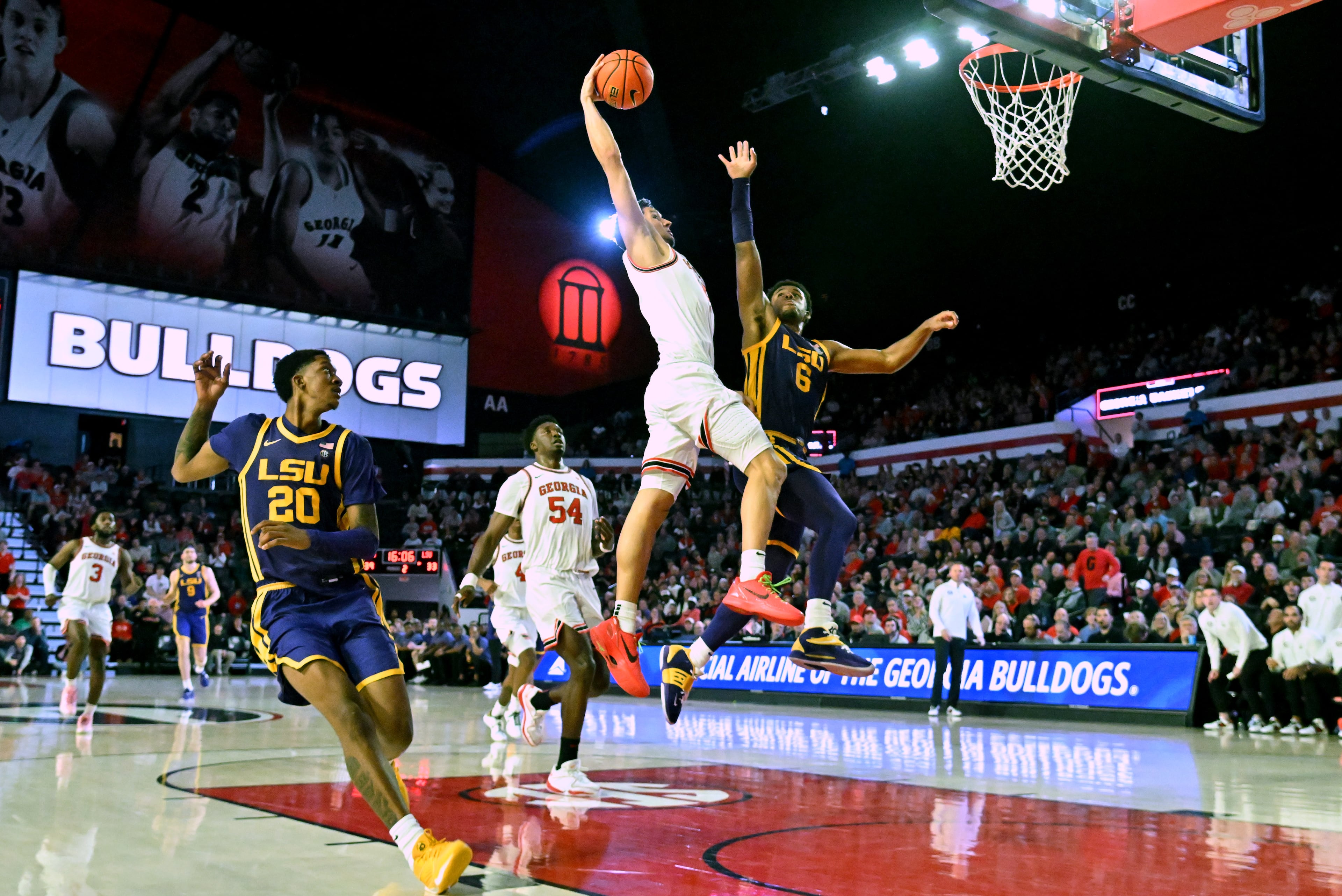 Georgia guard RJ Melendez (15) soars past LSU guard Jordan Wright (6) for a dunk during the second half of an NCAA college basketball game at Stegeman Coliseum, Wednesday, January 24, 2024, in Athens. Georgia won 68-66 over LSU. (Hyosub Shin / Hyosub.Shin@ajc.com)