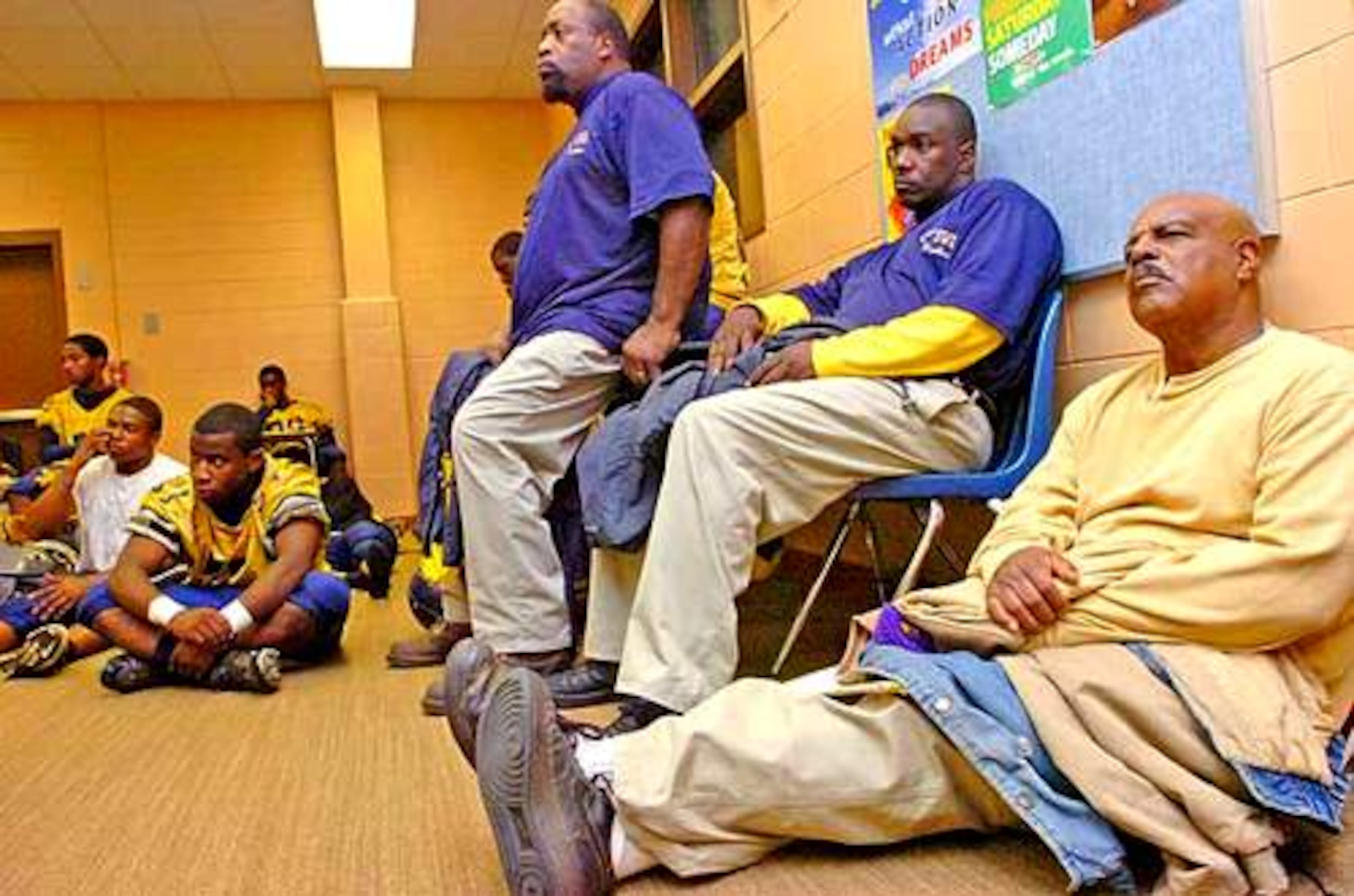 Well, Godfrey (in yellow sweater) is the legendary head football coach at SW DeKalb High...