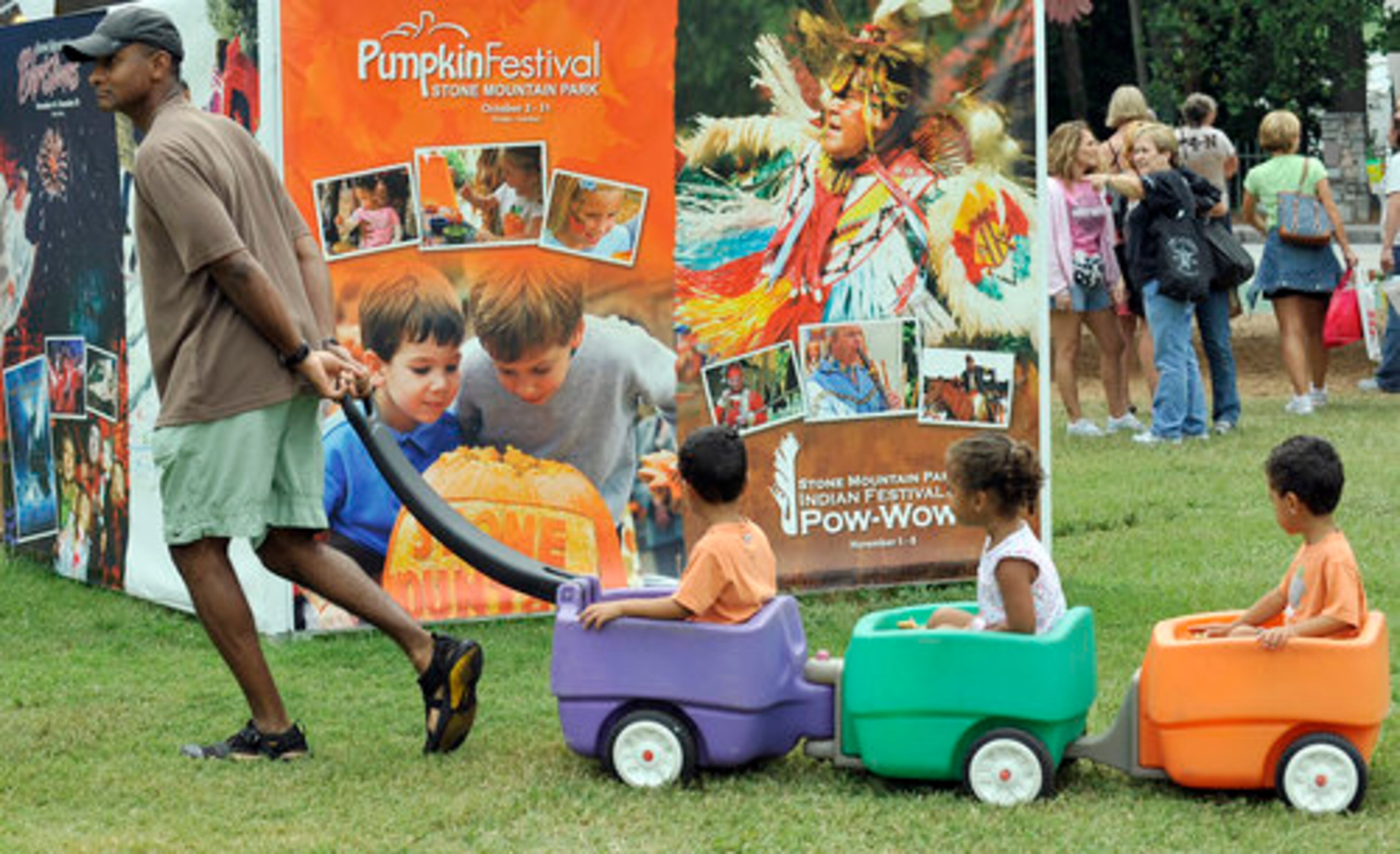 Thom Clark of Lilburn, and his 3-year old triplets, from left, Ethan, Clair, and Samuel head to the food court for a break.
