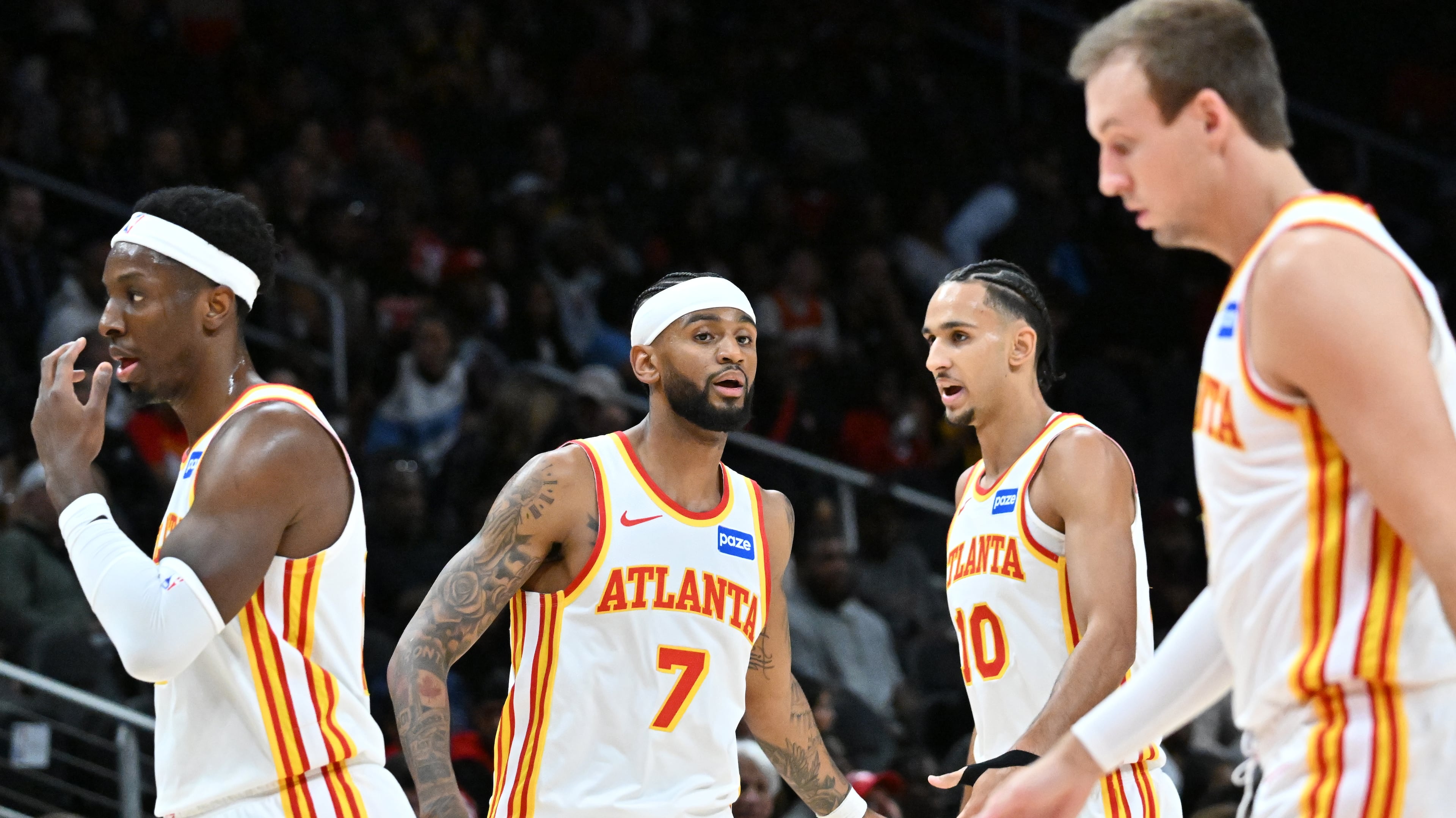 Atlanta Hawks forward/center Onyeka Okongwu (from left), guard Nickeil Alexander-Walker, forward Zaccharie Risacher and guard Luke Kennard react during a preseason game at State Farm Arena, Thursday, Oct. 16, 2025, in Atlanta. (Hyosub Shin/AJC)