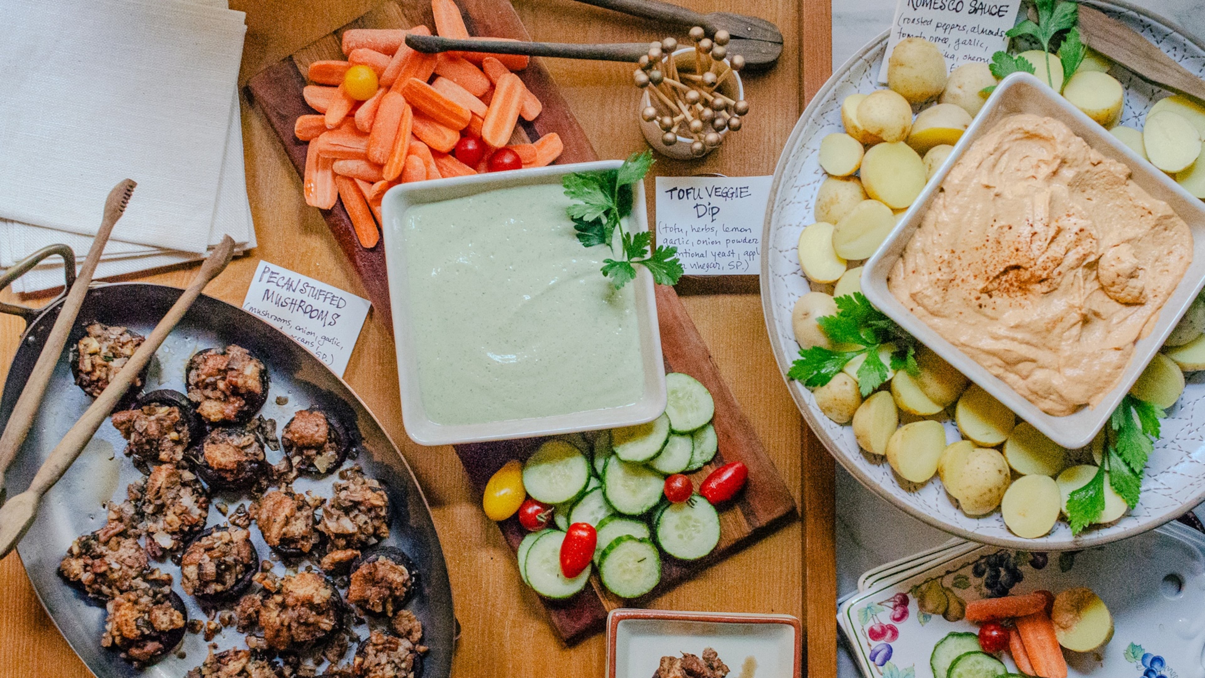 Vegan holiday hors d’oeures satisfy a variety of dietary needs and wants. From left: Pecan Stuffed Mushrooms, Tofu Veggie Dip and Romesco Sauce with Potatoes. (Virginia Willis for The Atlanta Journal-Constitution)