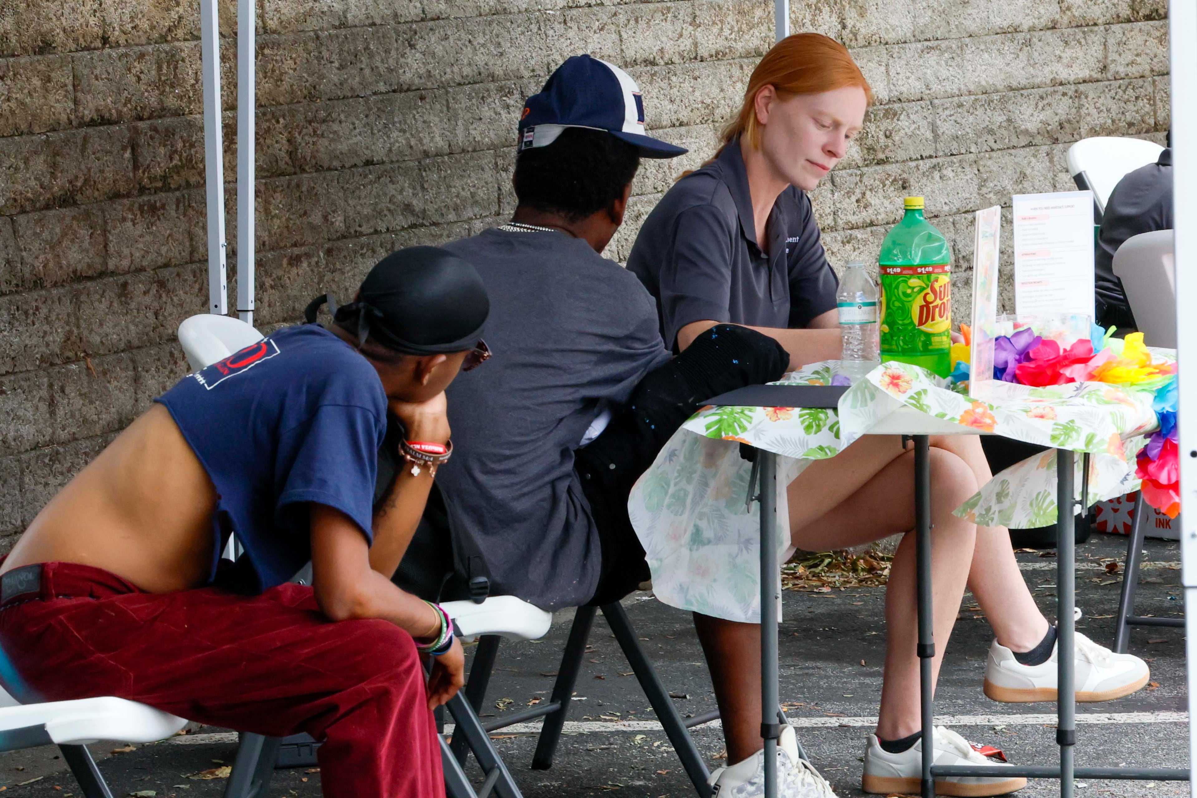 Behavioral health therapist Mackenzie Brees provides free assessments to clients at an HIV testing event organized by the Empowerment Resource Center on June 25, 2025. (Miguel Martinez/AJC)