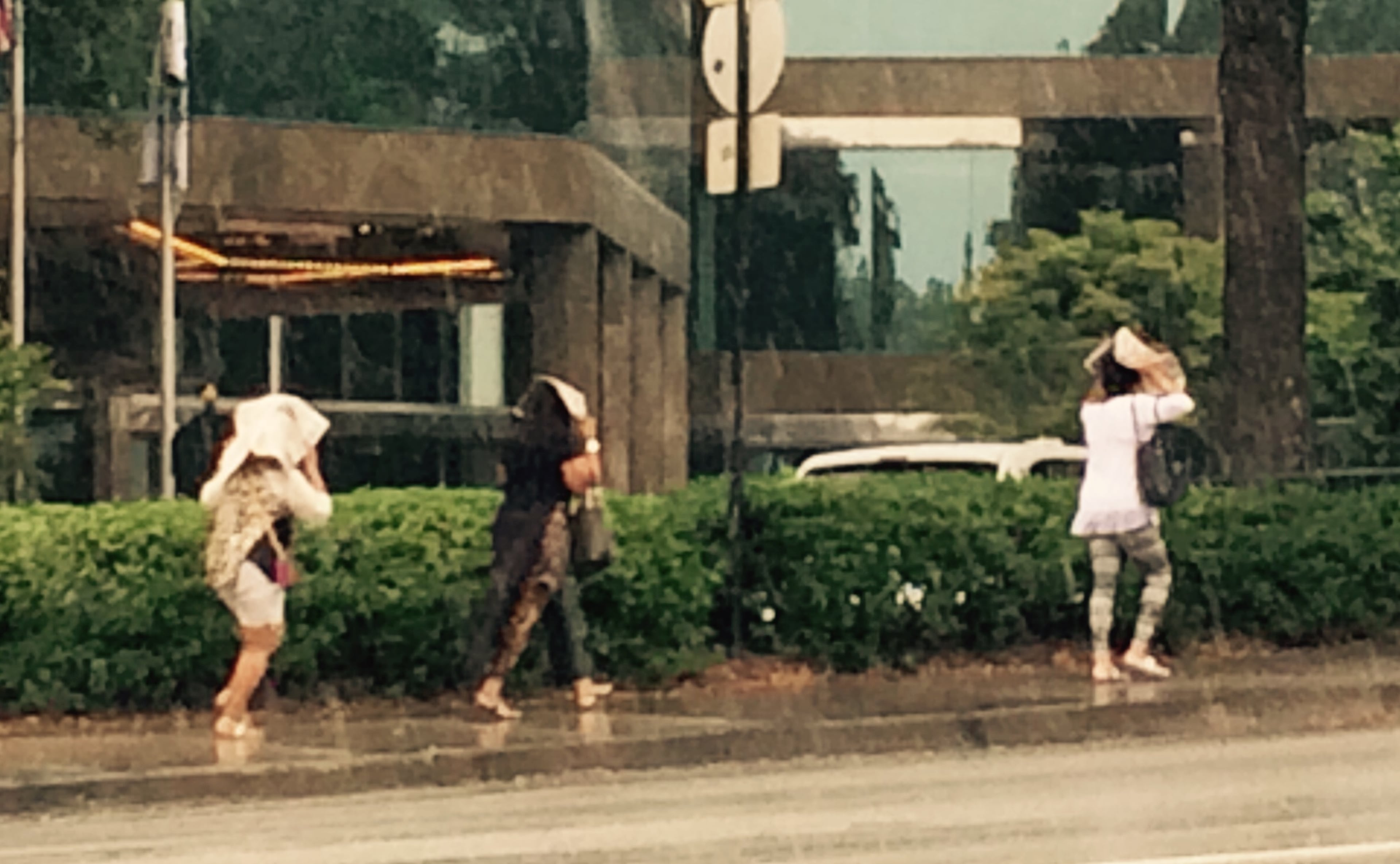Ladies use dead-tree version of the newspaper in an attempt to stay dry. You just can't do that with the Internet. (Bill Torpy/AJC)