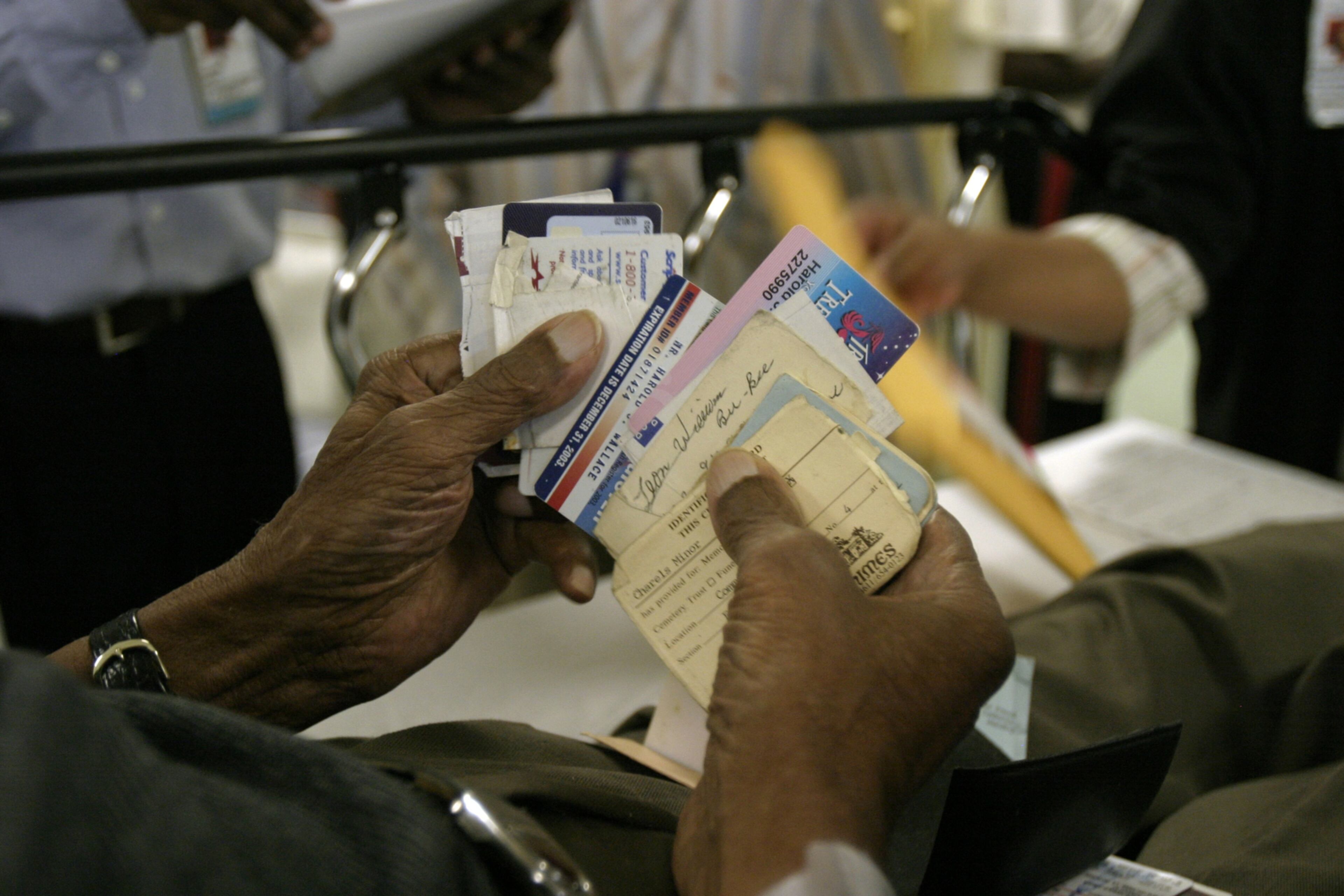 050902 - ATLANTA, GA -- A 96-year-old man tries to find his medical card as he is brought into Grady Hospital Emergency Room on Friday, September 2, 2005. (Mikki K. Harris/AJC staff)