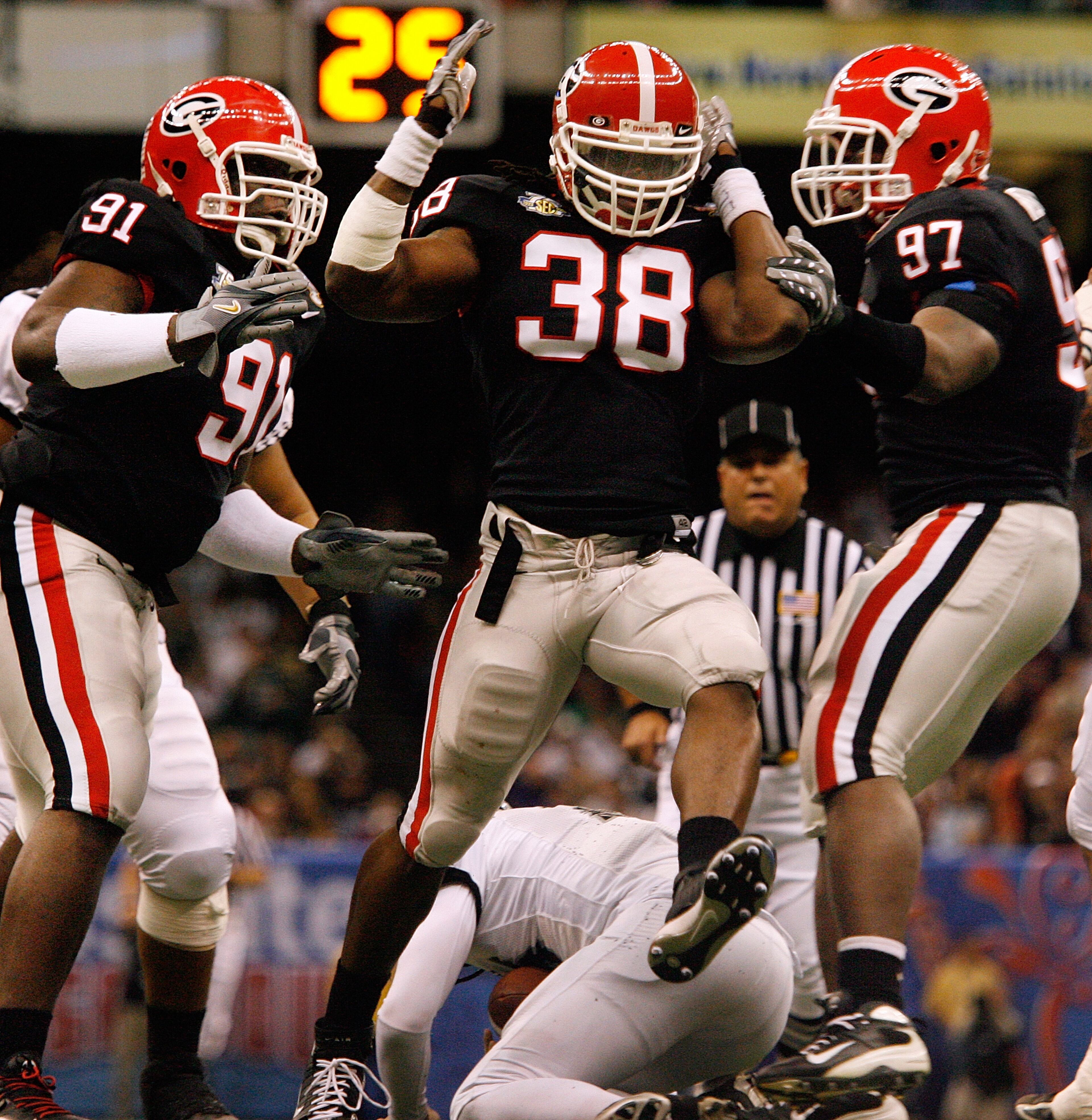 Georgia defensive end Marcus Howard (38) celebrates a sack of Hawaii quarterback Colt Brennan in the Sugar Bowl on Jan. 1, 2008 in New Orleans. POUYA DIANAT / Staff
