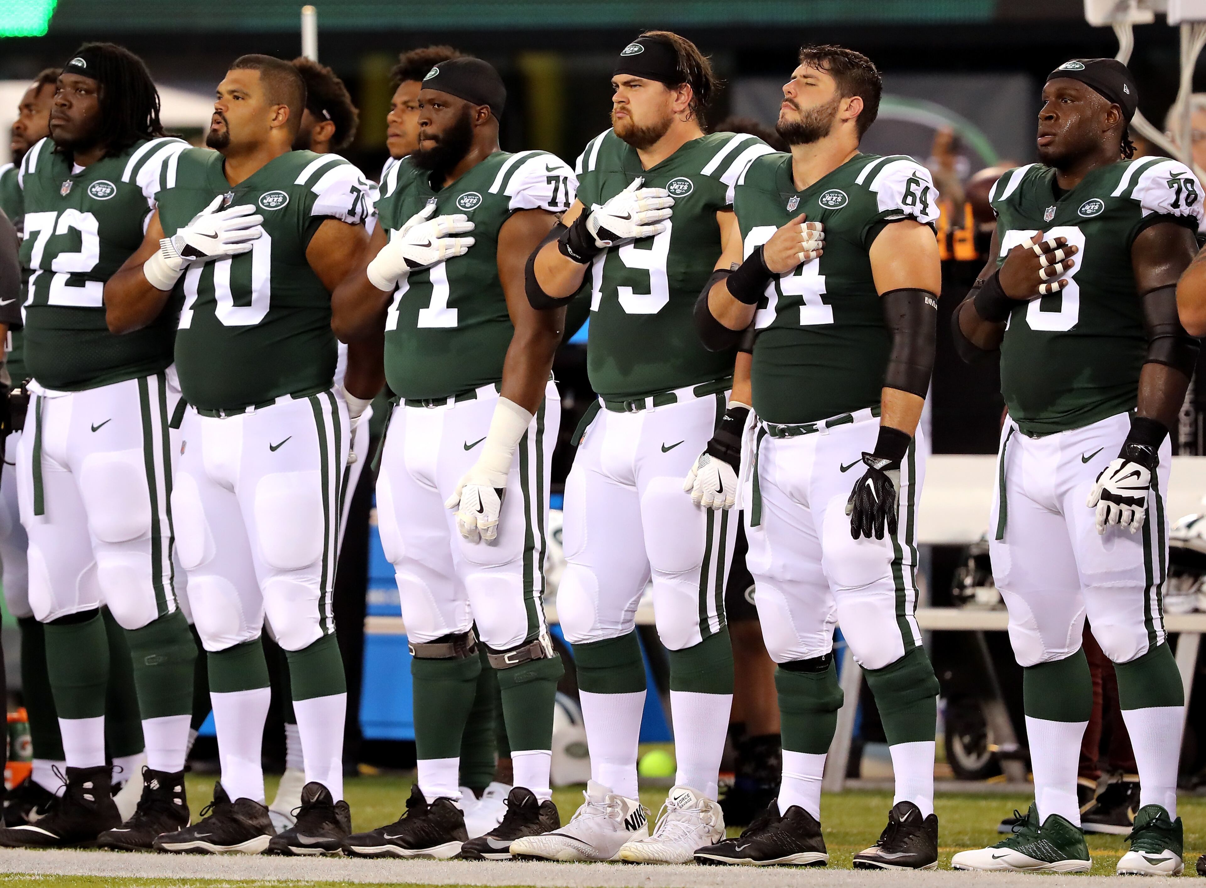 EAST RUTHERFORD, NJ - AUGUST 10: The New York Jets bench lines up for the national anthem before the game against the Atlanta Falcons during a preseason game at MetLife Stadium on August 10, 2018 in East Rutherford, New Jersey. (Photo by Elsa/Getty Images)