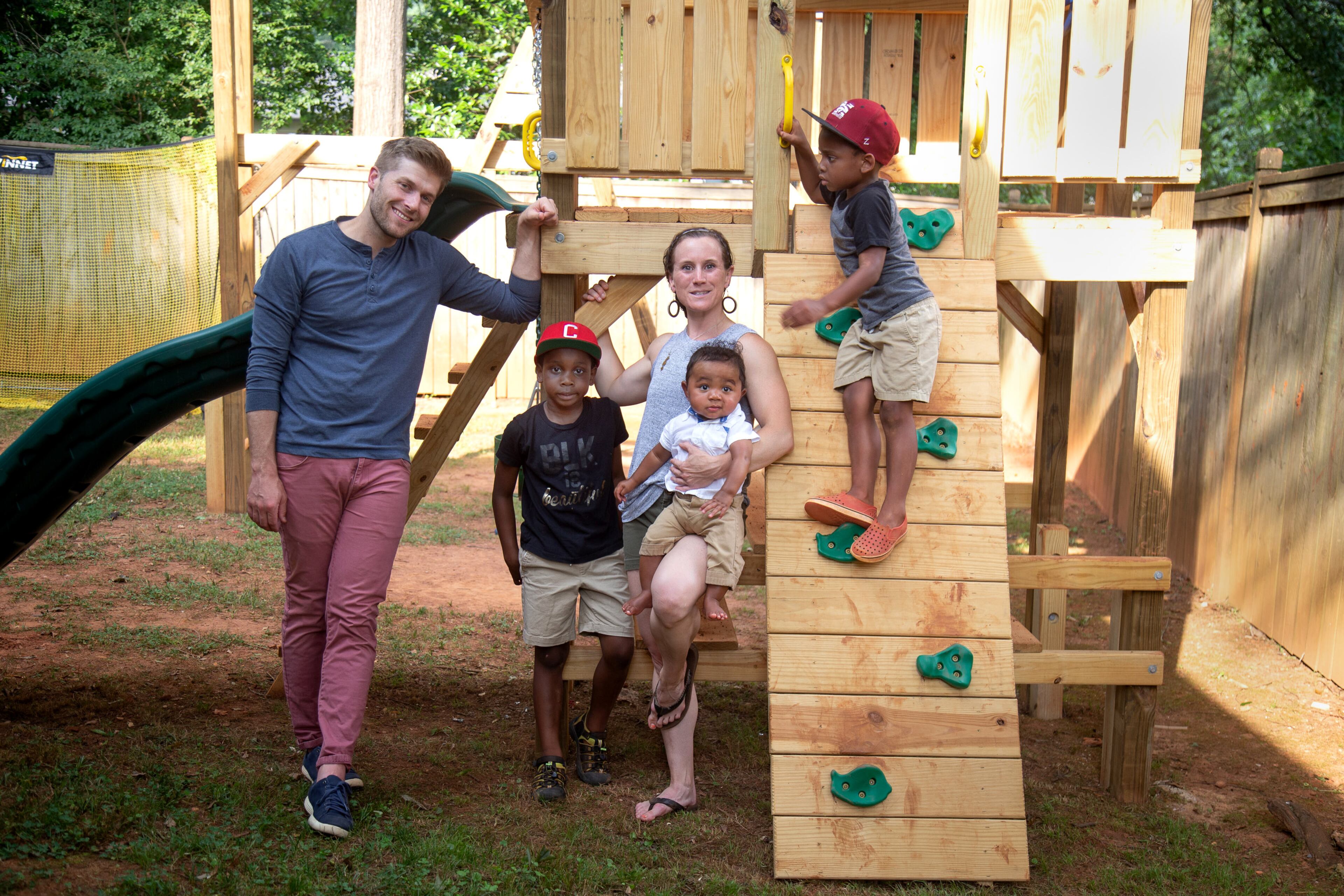 Zach and Brit Eyster and their three children - Clark (red hat), Mac (Morehouse College hat) and Cyrus (baby) - pose for a photograph in the back yard of their Decatur home July 15, 2020. STEVE SCHAEFER FOR THE ATLANTA JOURNAL-CONSTITUTION