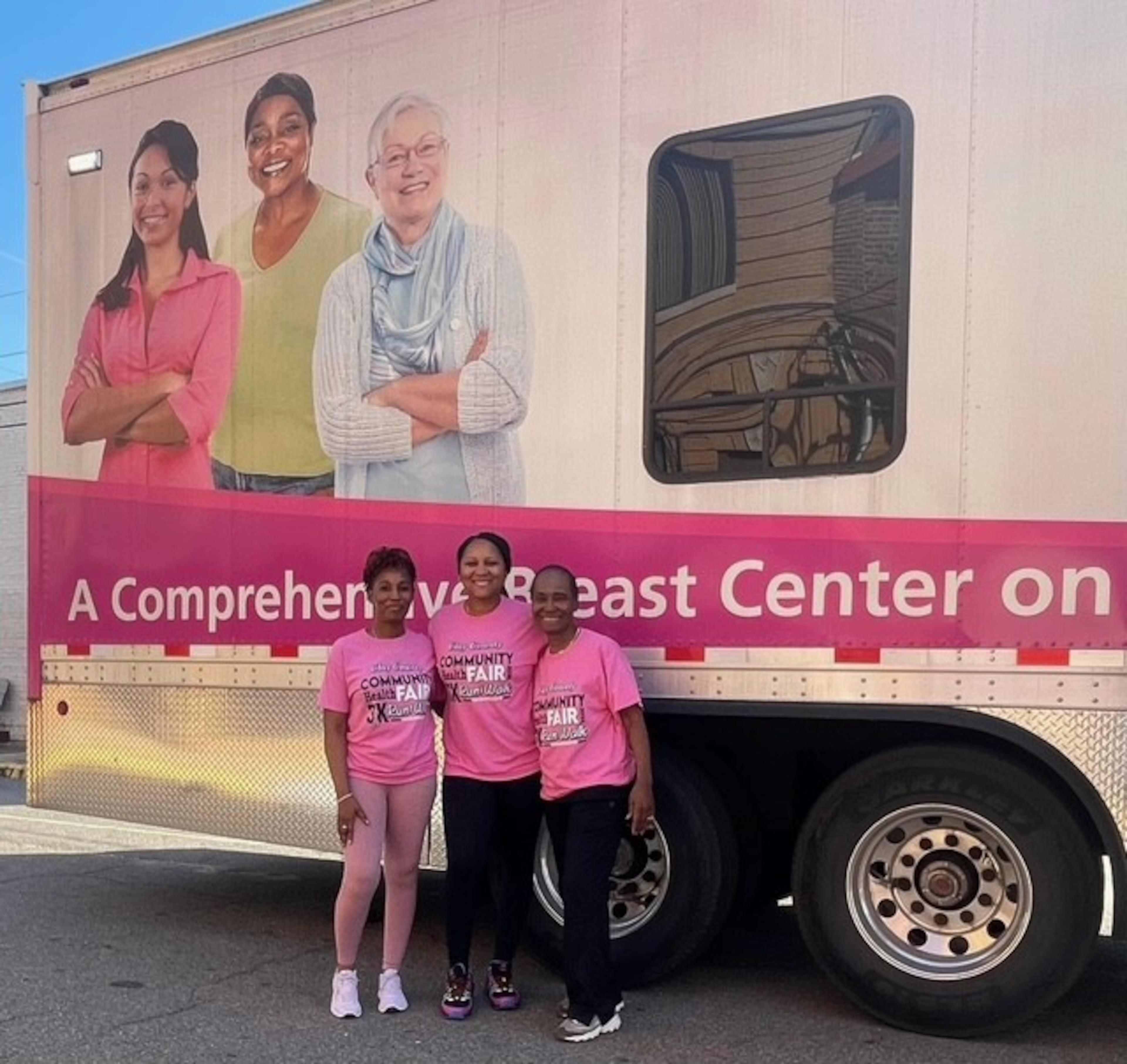 Dr. Rogsbert Phillips-Reed (right), Adrianne Clark (left) and DeUndrea Bankston stand in front of the Sisters by Choice mobile breast clinic, which provides mammography screenings in communities across Georgia. (Courtesy of Sisters by Choice)