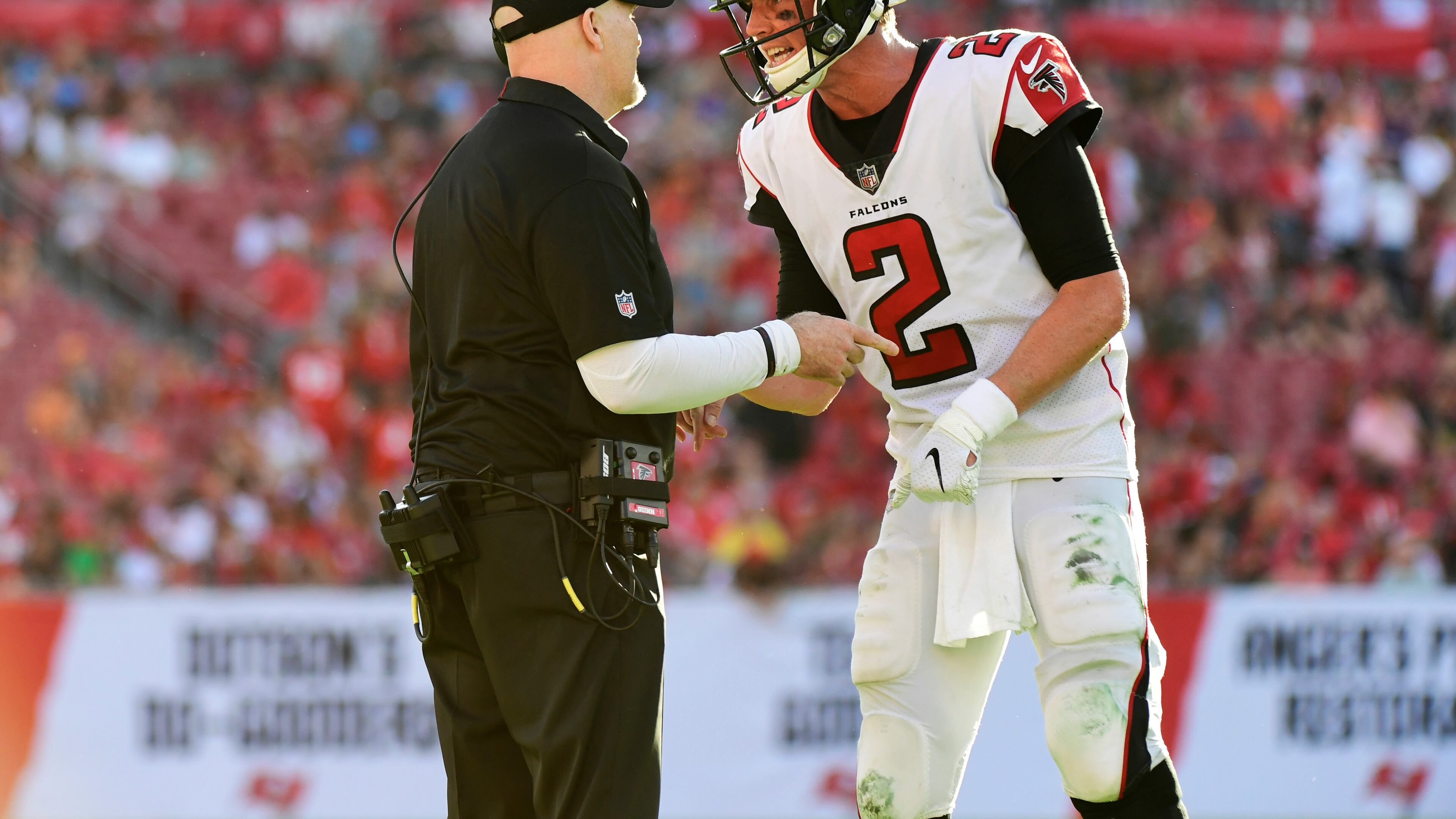 Falcons head coach Dan Quinn and quaterback Matt Ryan discuss the next play during the final minute of a 34-32 win over Tampa Bay Buccaneers Dec. 30, 2018, at Raymond James Stadium in Tampa, Fla.