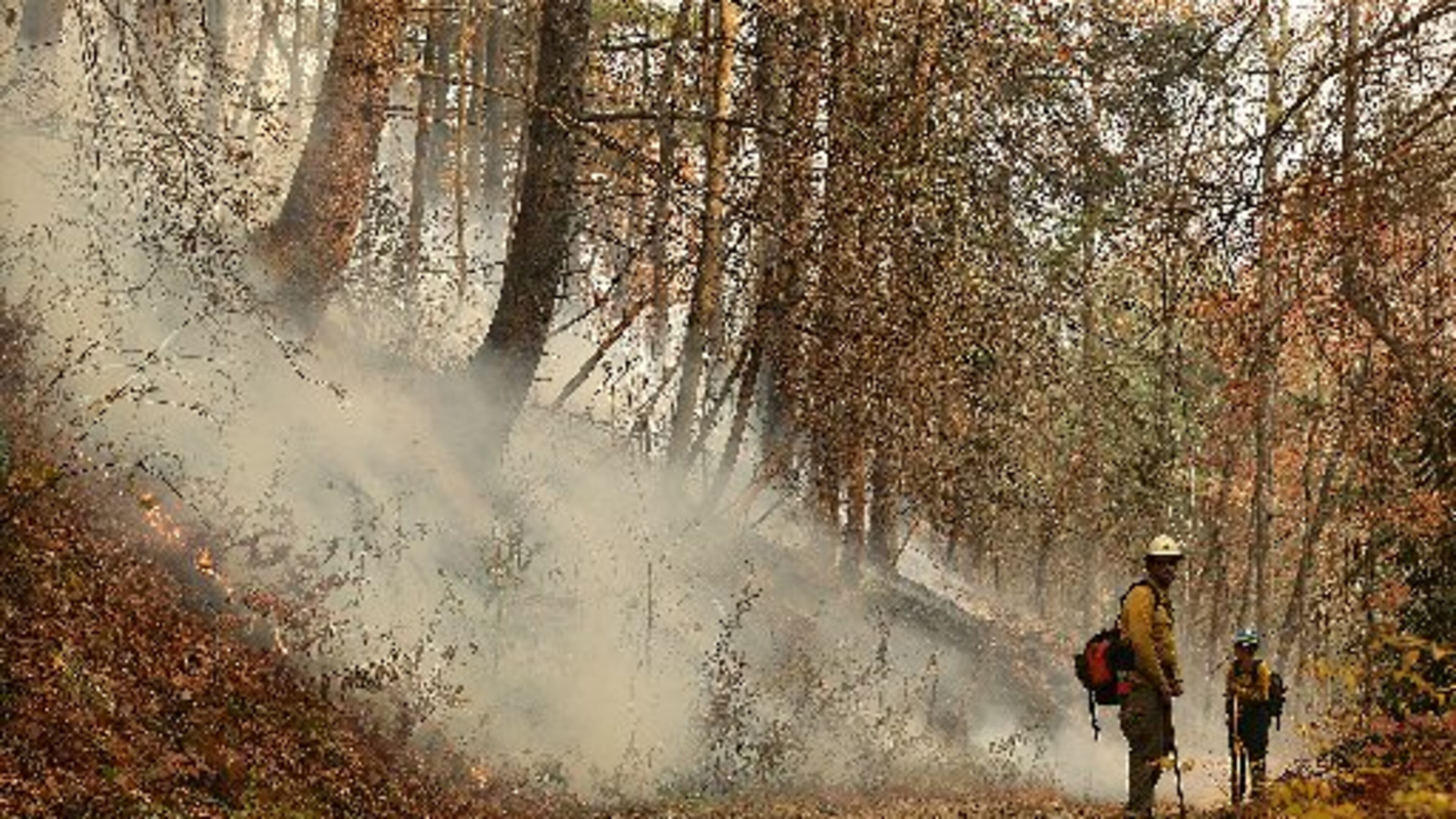 Firefighters from Montana hold the line of the Rock Mountain fire in Clayton earlier this week. It spans more than 9,300 acres and is 30 percent contained. CURTIS COMPTON / CCOMPTON@AJC.COM
