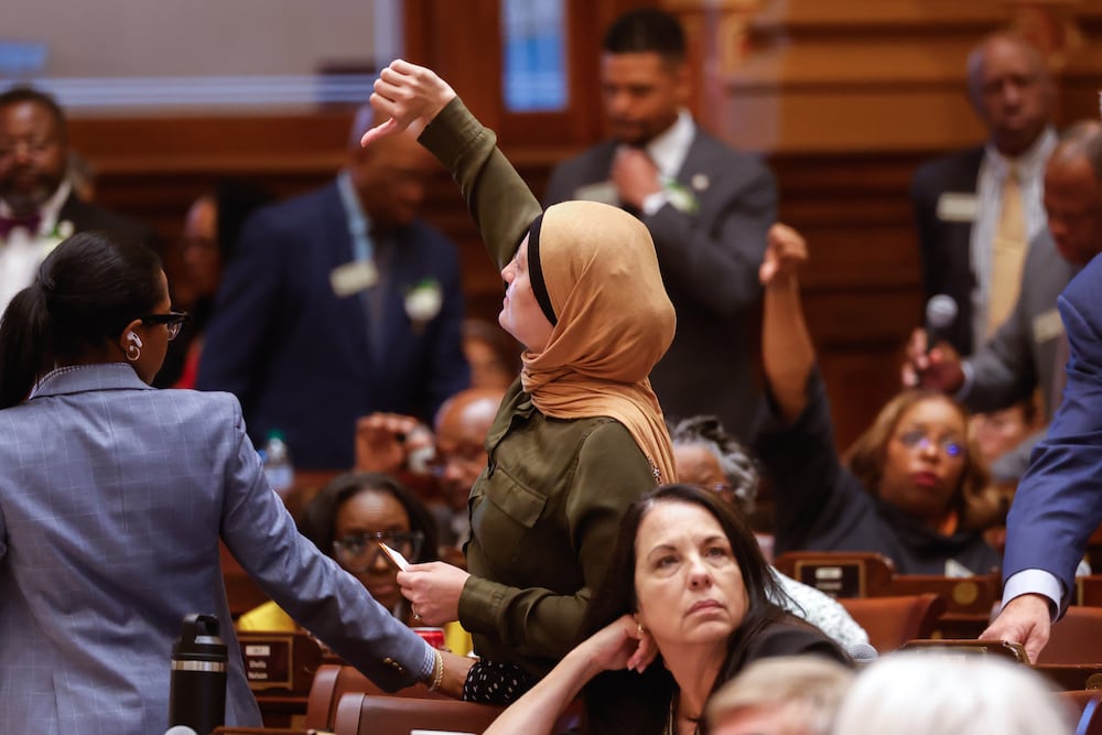 State Rep. Ruwa Romman, D-Duluth, gives a thumbs-down on a motion regarding property tax legislation during the special session at the state Capitol on Saturday. (Arvin Temkar/AJC)